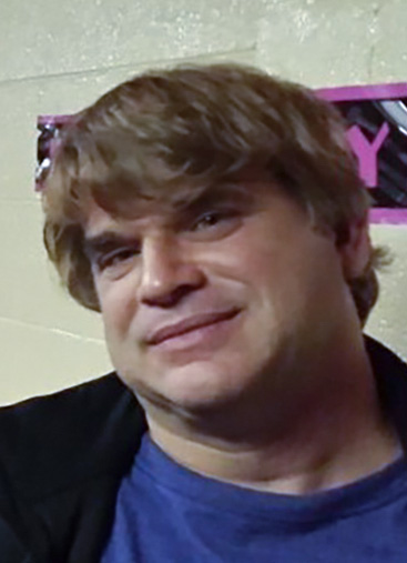 This October 2015 photo provided by John Michels, left, shows his brother Paul Andre Michels, right, posing with his sister Sarah Michels and himself, in Allen Park, Michigan. Paul Michels was among eight people killed March 16, 2021, in shootings at three Georgia massage parlors in the Atlanta area. (John Michels via AP)