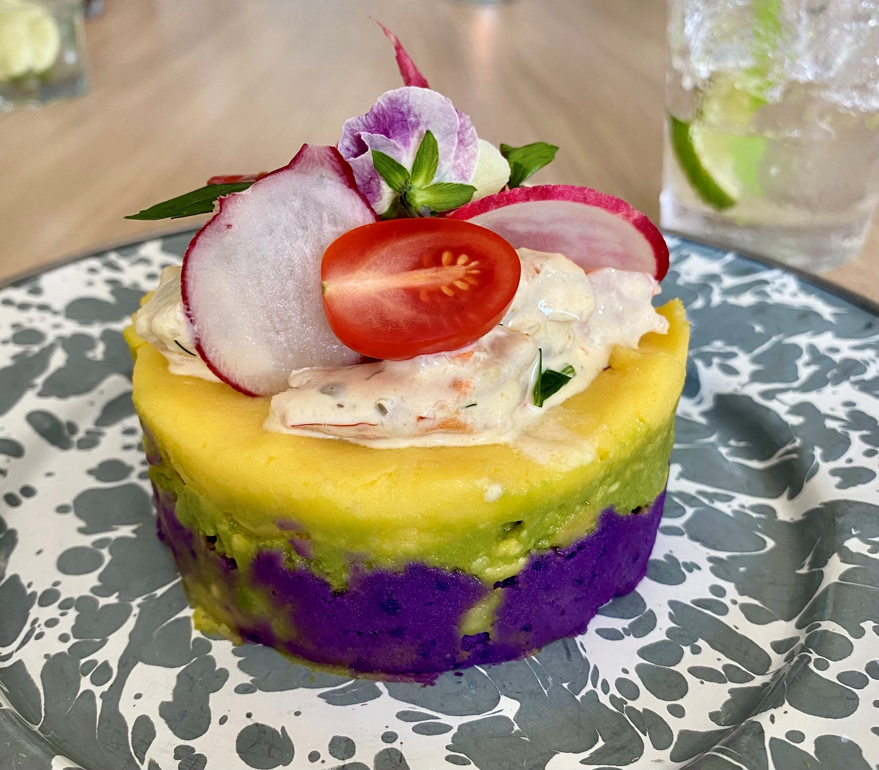 At a recent pop-up dinner at Silver Queen restaurant in Monroe, La Chingana chef Arnaldo Castillo served this Peruvian causa, layered with purple potato, avocado, white potato and shrimp salad. Wendell Brock for The Atlanta Journal-Constitution