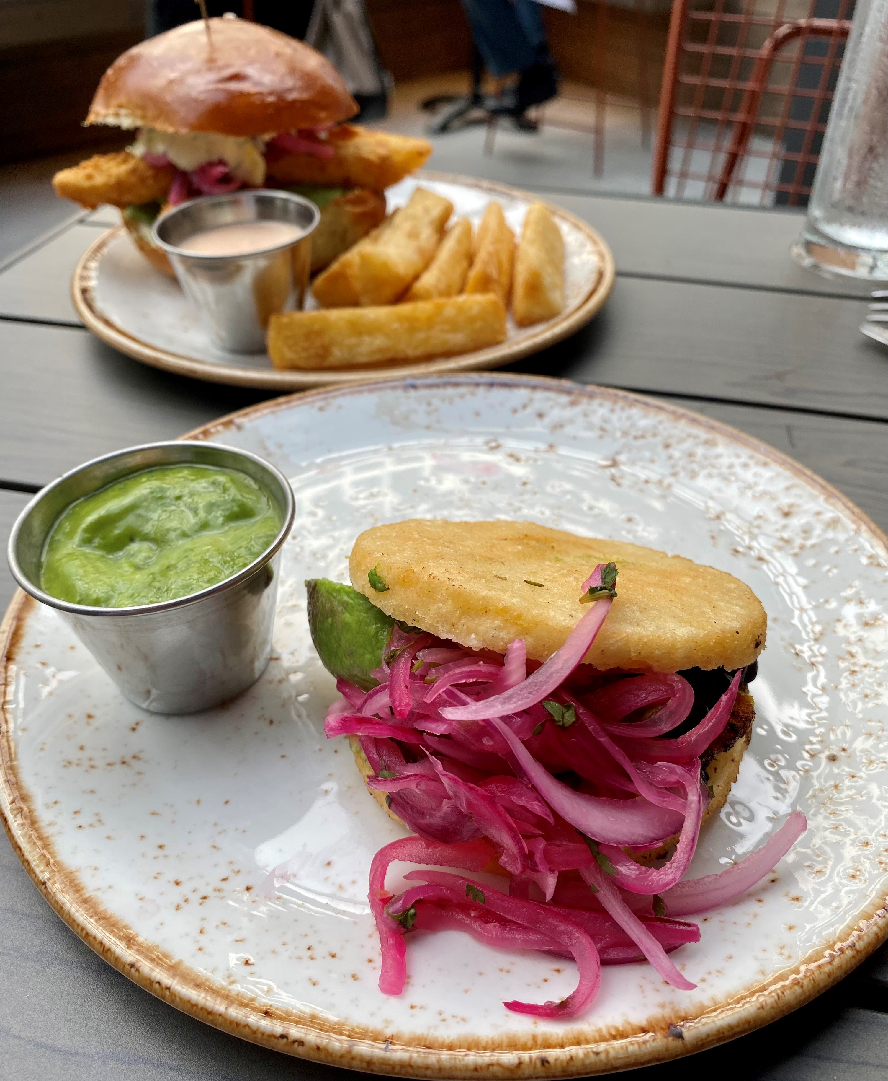 At El Vinedo Local, Uruguayan-born executive chef Bruno Vergara makes South American dishes like this arepa vegetales (front) and pan con pescado (fried fish sandwich, rear).
Wendell Brock for The Atlanta Journal-Constitution