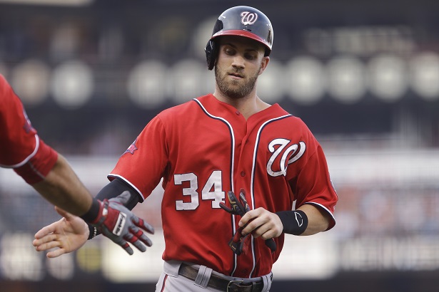 Washington Nationals' Bryce Harper is congratulated after scoring against the San Francisco Giants during the first inning of a baseball game Saturday, Aug. 15, 2015, in San Francisco. Harper scored on a double by Nationals' Yunel Escobar. (AP Photo/Ben Margot)
