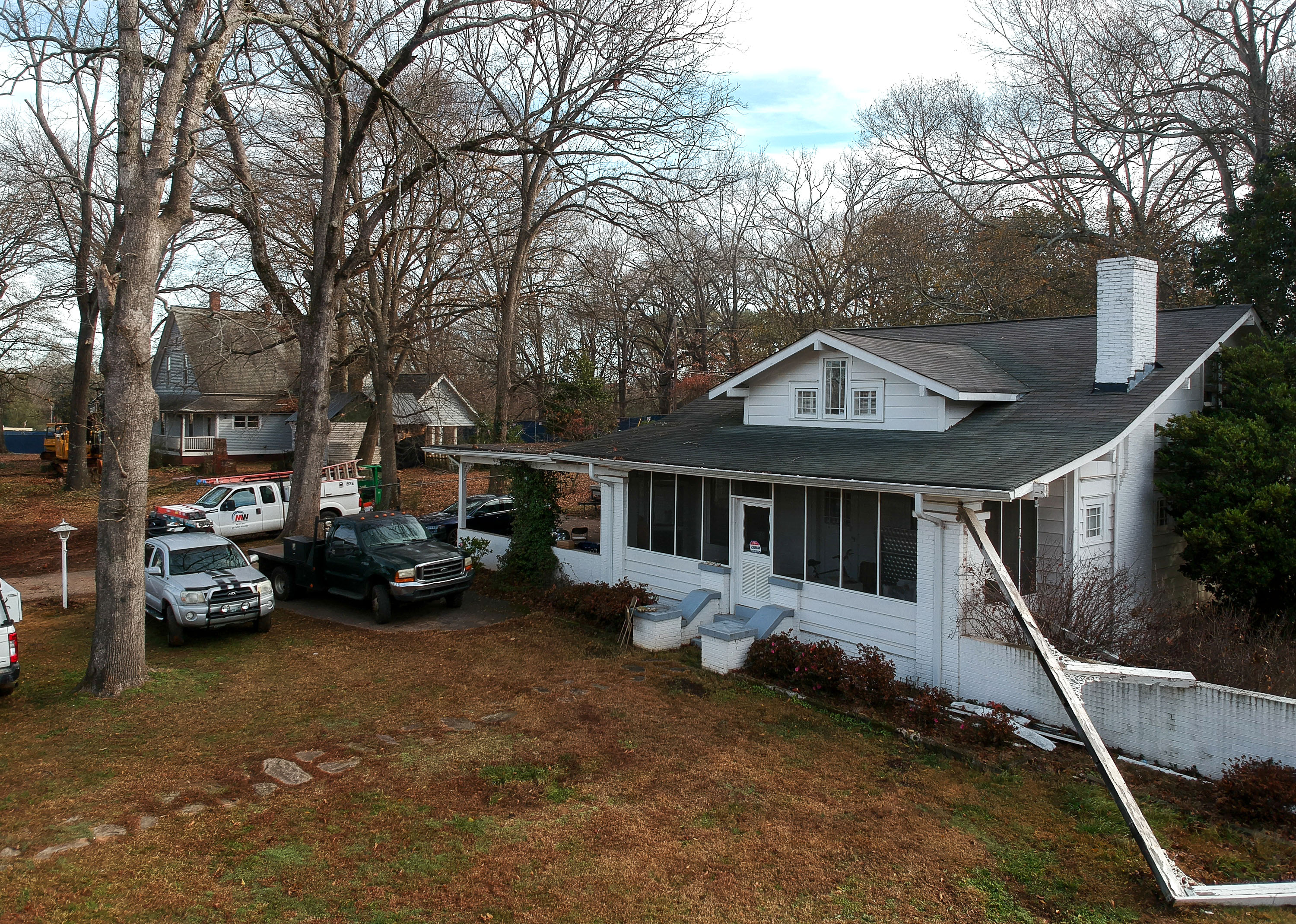The NAMB hopes to demolish this house at 961 Rowland Street, and another (visible in the background through the trees) at 3673 Hill Street. STEVE SCHAEFER / SPECIAL TO THE AJC