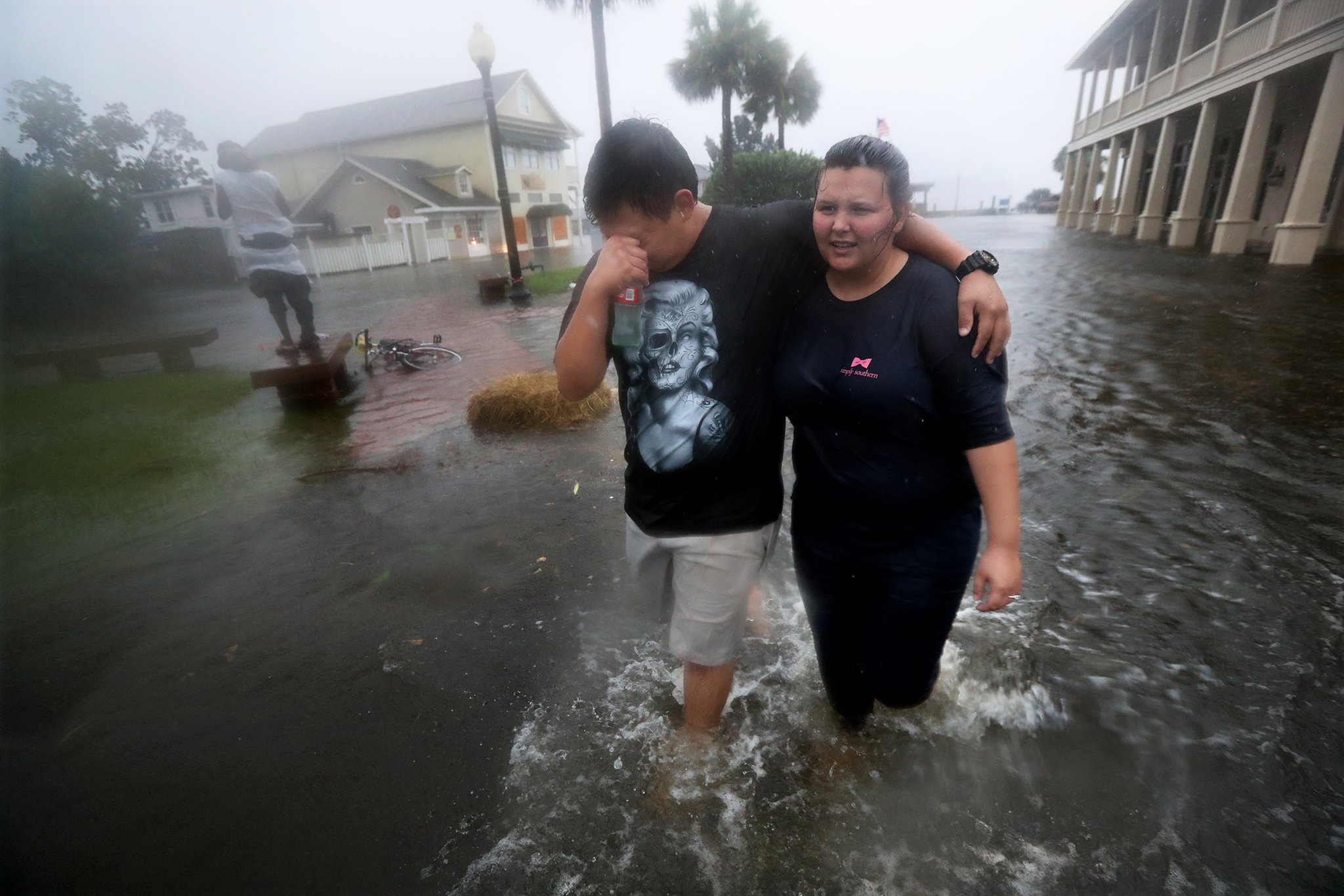 Michael and Tori Munton make their way through the flooded streets of downtown historic Saint Marys, Ga., as the storm surge from Hurricane Matthew hits on Friday, Oct. 7, 2016. Curtis Compton /ccompton@ajc.com