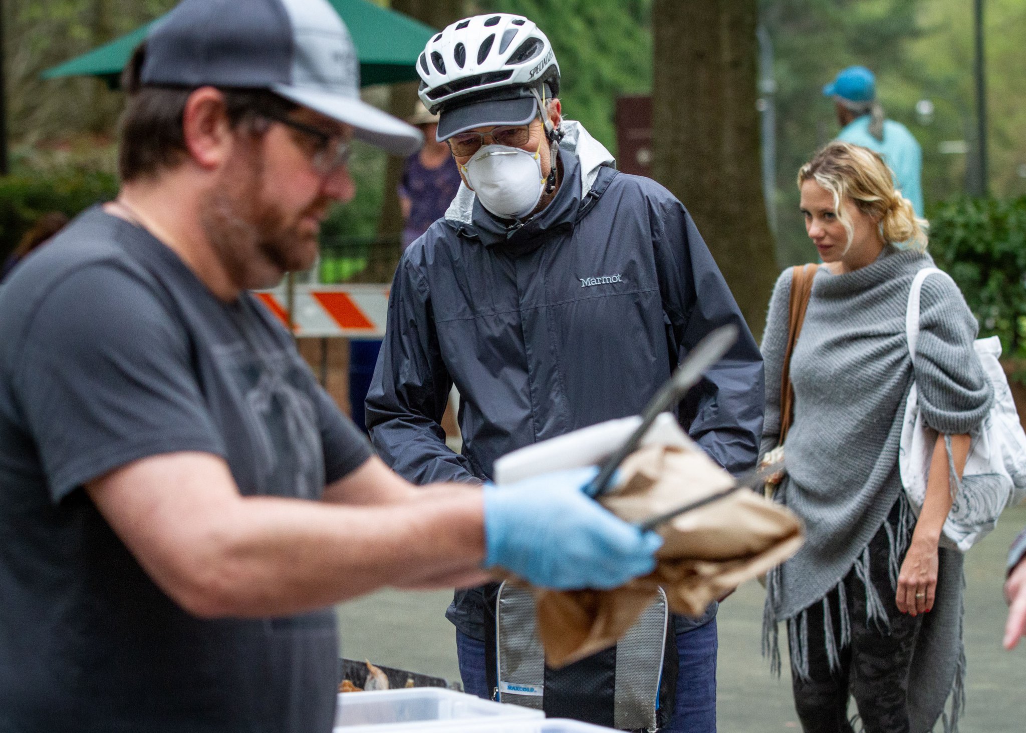 Walter Brown (center) orders fresh bread last spring at the Freedom Farmers Market at the Carter Center. Steve Schaefer for The Atlanta Journal-Constitution