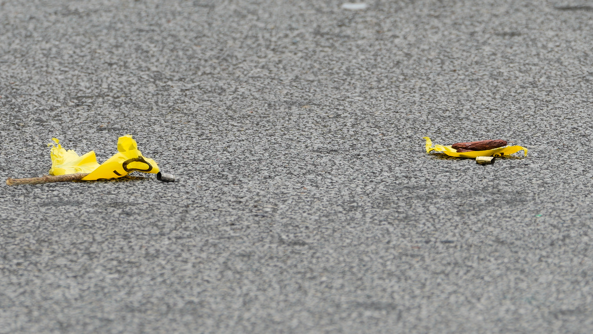 Shell casings are seen marked by crime scene tape outside the Luxury Nail Spa in East Point.