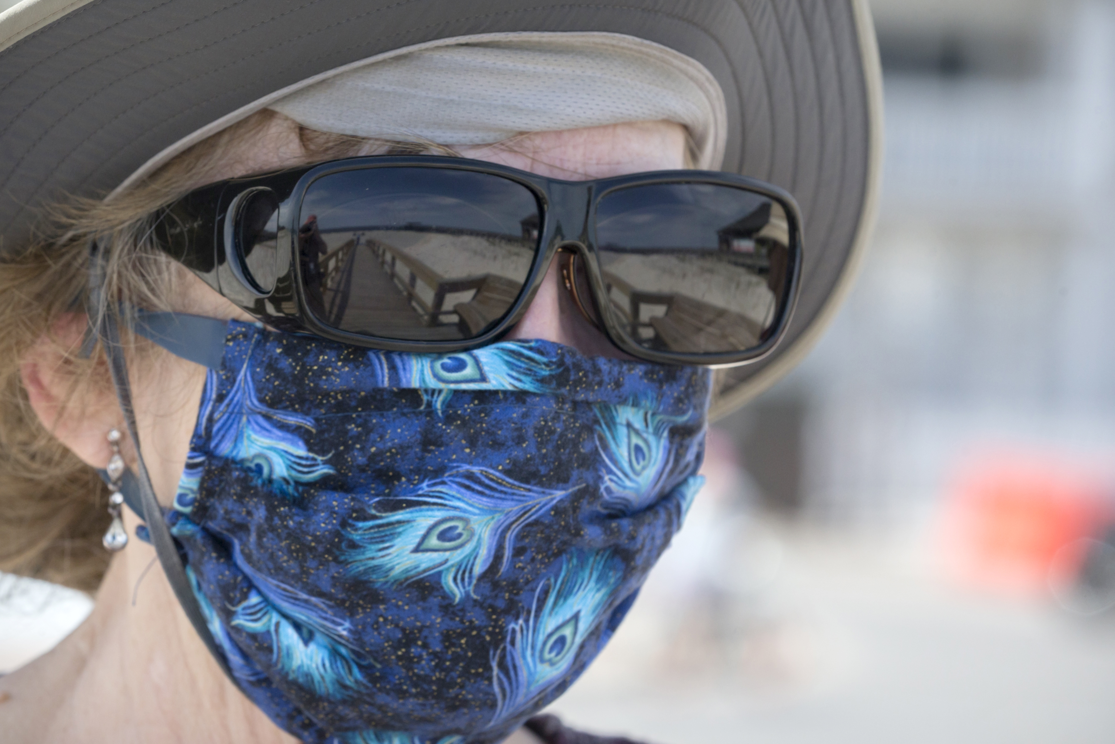 A local visitor walks along a dune crossover to Tybee Island beach with her handmade face mask on Saturday, April 4, 2020, a day after Gov. Brian Kemp signed an executive order allowing people to exercise outside, with social distancing of at least 6 feet. (Photo: Stephen B. Morton/Special to the AJC)