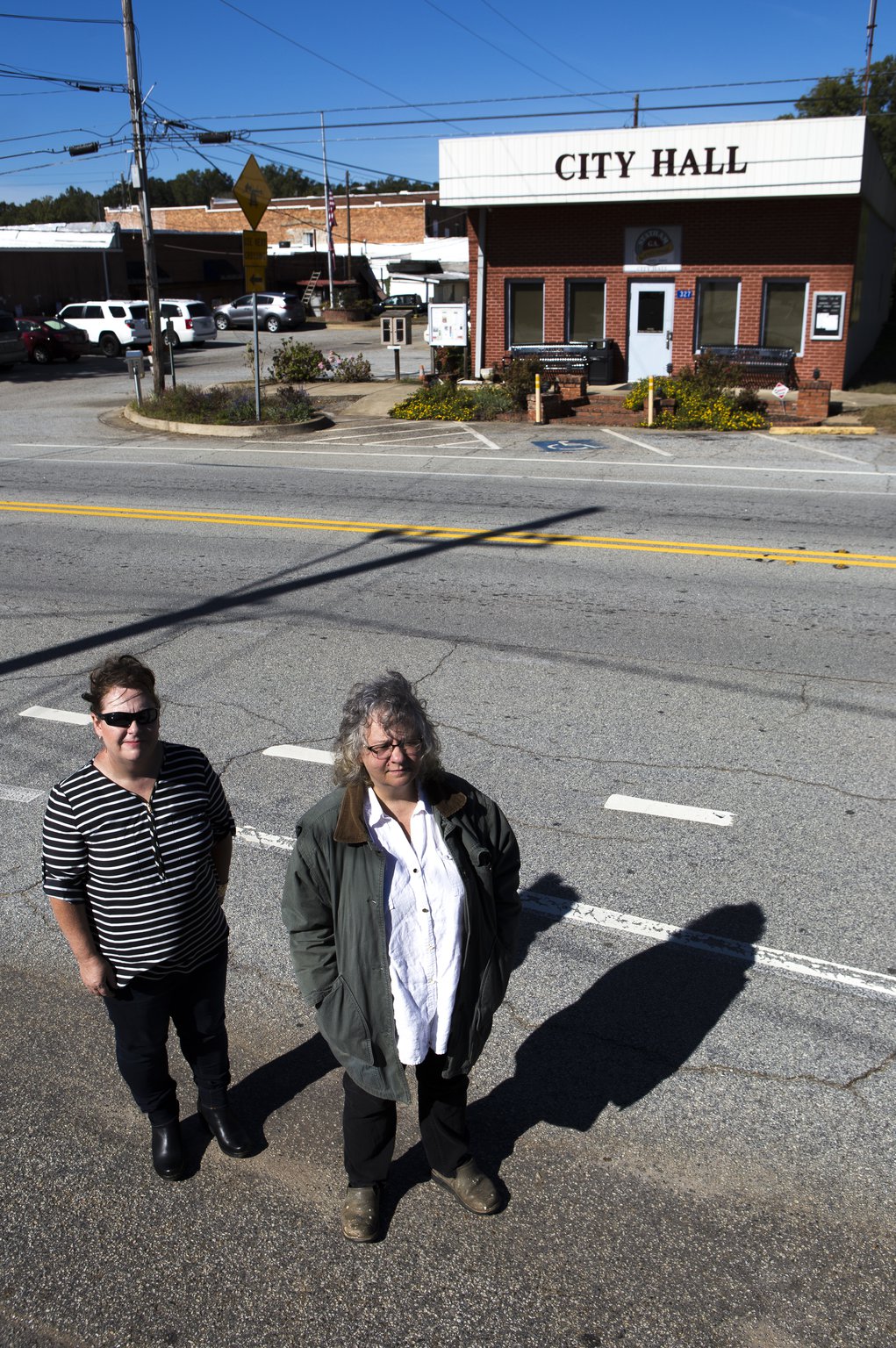 Catherine Corkren (left), 47, of Atlanta and Sondra Moore, 47, of Hoschton, Ga., pose for a portrait across the road from Statham City Hall in Statham, Ga., on Wednesday, Oct. 24, 2018.