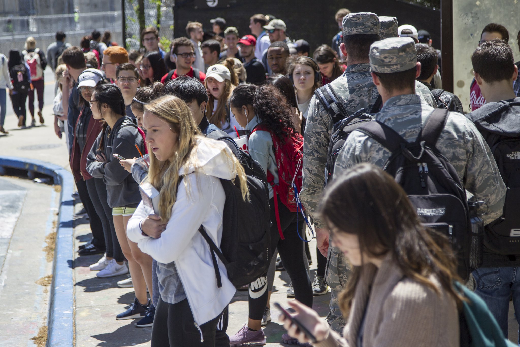 University of Georgia students wait for buses at the Tate Student Center bus stop on the University of Georgia campus in Athens, Georgia in this AJC file photo.