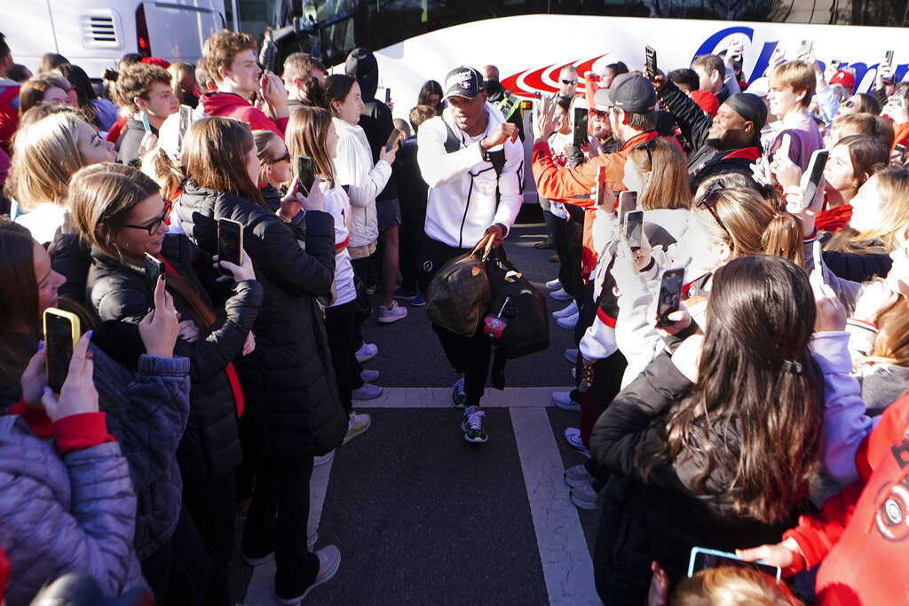 Georgia running back Zamir White is greeted by a large crowd of fans as he and his teammates return to the Georgia campus, Tuesday, Jan. 11, 2022, in Athens, Ga., after defeating Alabama in the College Football Championship NCAA college football game. (AP Photo/John Bazemore)