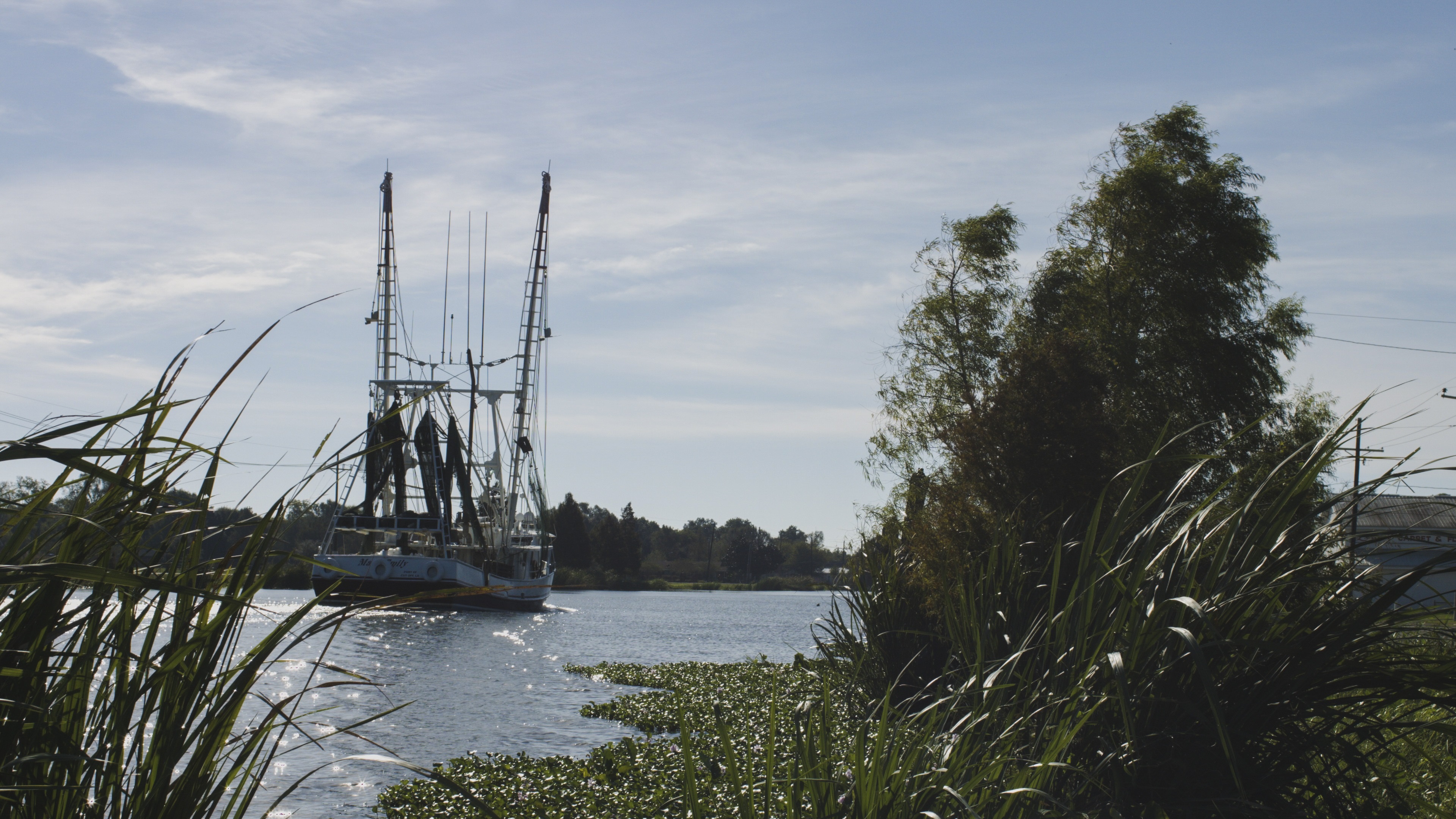 Shrimp boats travel Louisiana’s Bayou Lafourche on their way to the Gulf of Mexico. / Courtesy of Louisiana’s Cajun Bayou Tourism