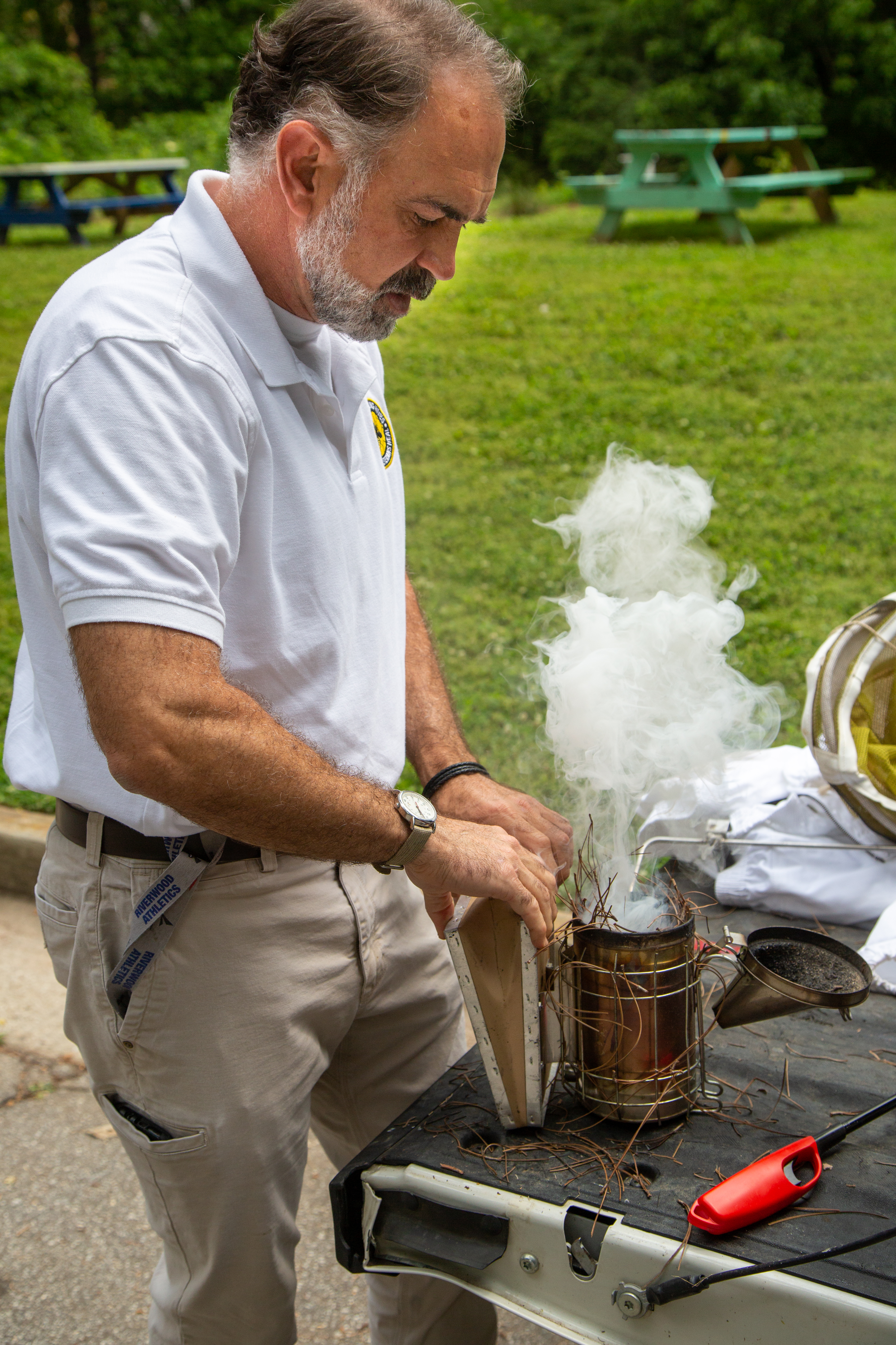 Tim Doherty prepares a smoker before checking on the bee hives at Mountain Way Common Park in Buckhead. PHIL SKINNER FOR THE ATLANTA JOURNAL-CONSTITUTION.