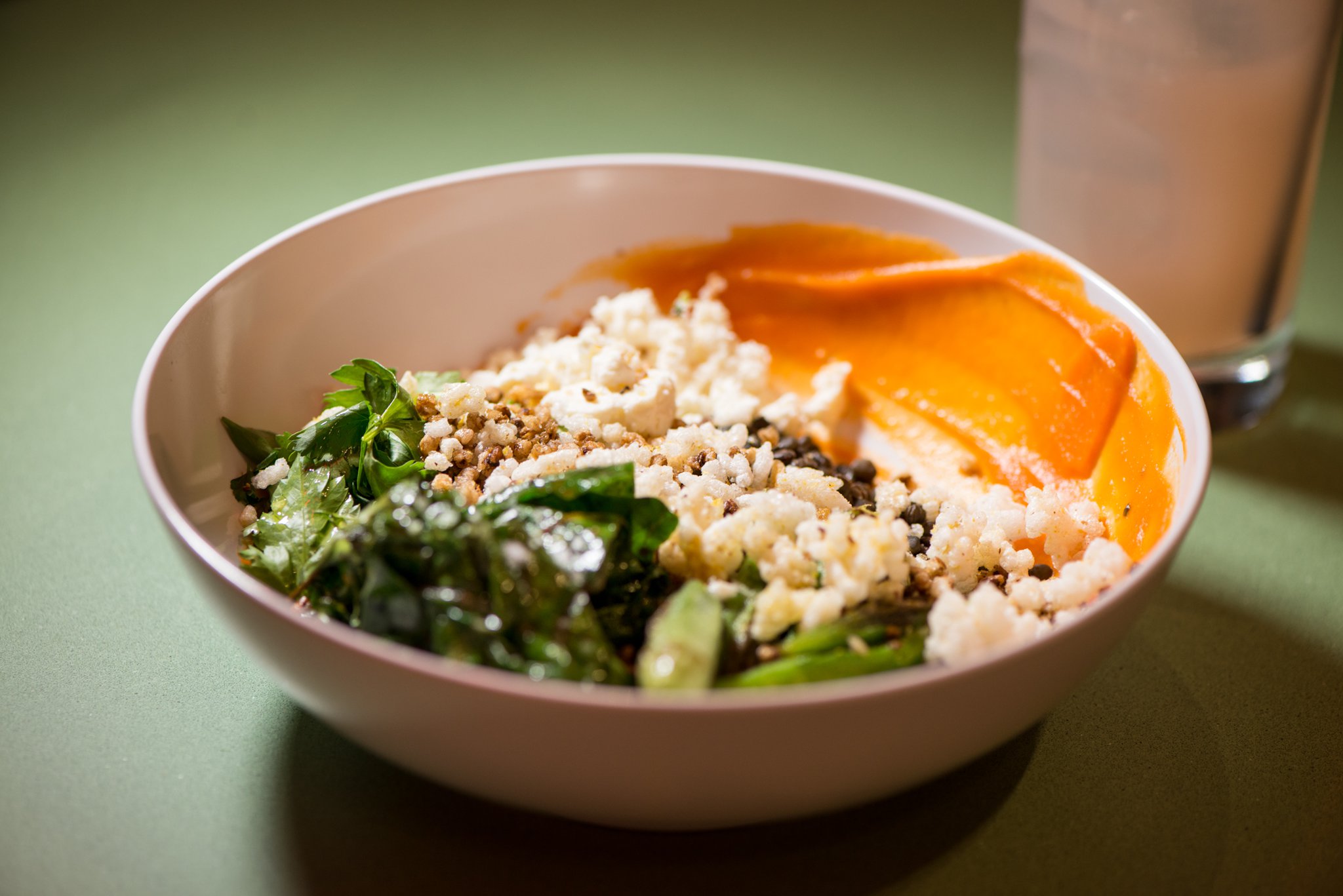 Casablanca Bowl with beluga lentils, buckwheat crunchies, puffed rice, moroccan-spiced carrot puree, swiss chard, seared okra, feta, and herb salad. Photo credit- Mia Yakel.