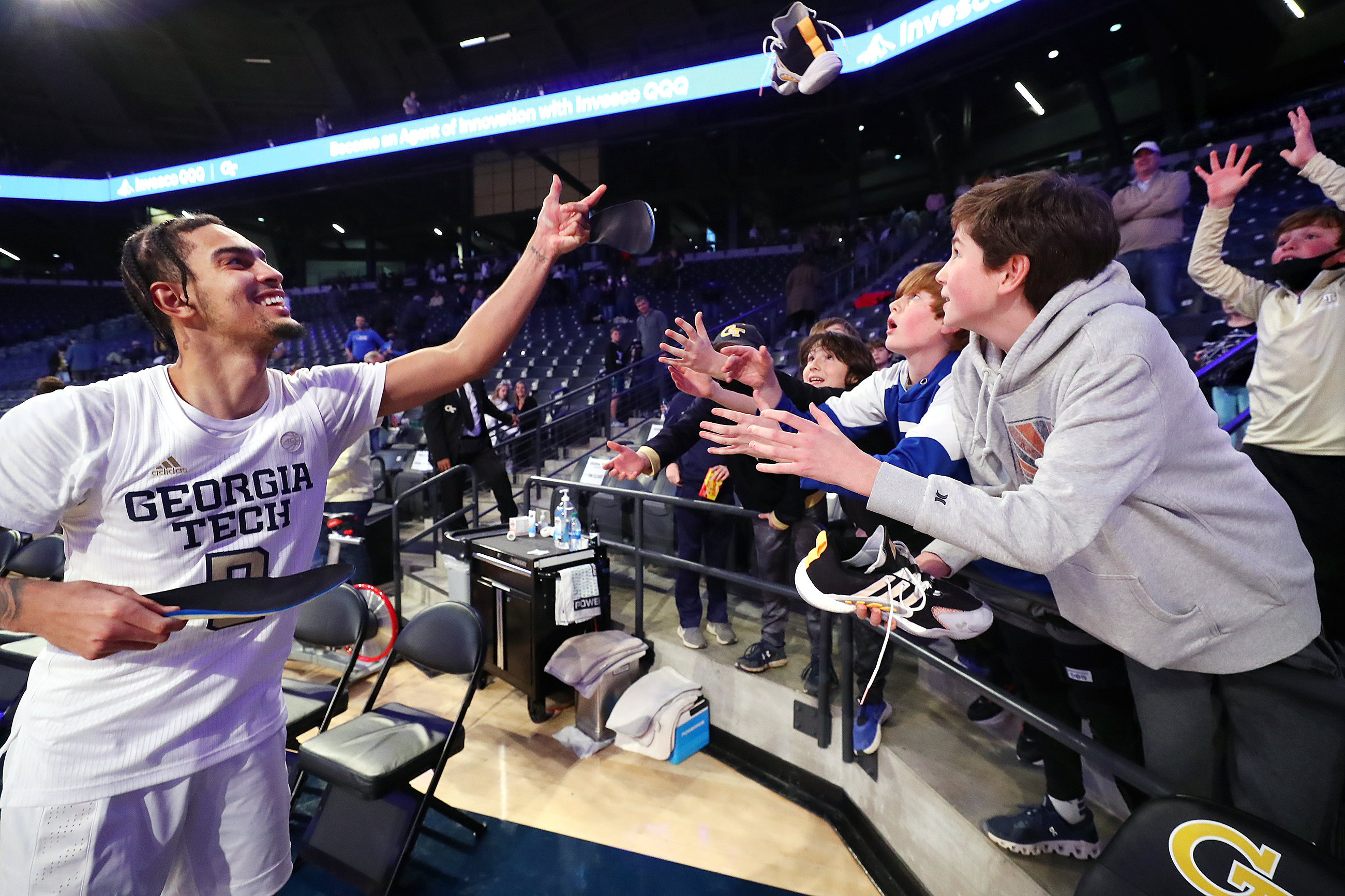 012322 Atlanta: Georgia Tech guard Michael Devoe autographs and tosses his shoes to young fans following a 103-53 victory over Clayton State in a NCAA college basketball game on Sunday, Jan. 23, 2022, in Atlanta. “Curtis Compton / Curtis.Compton@ajc.com”`