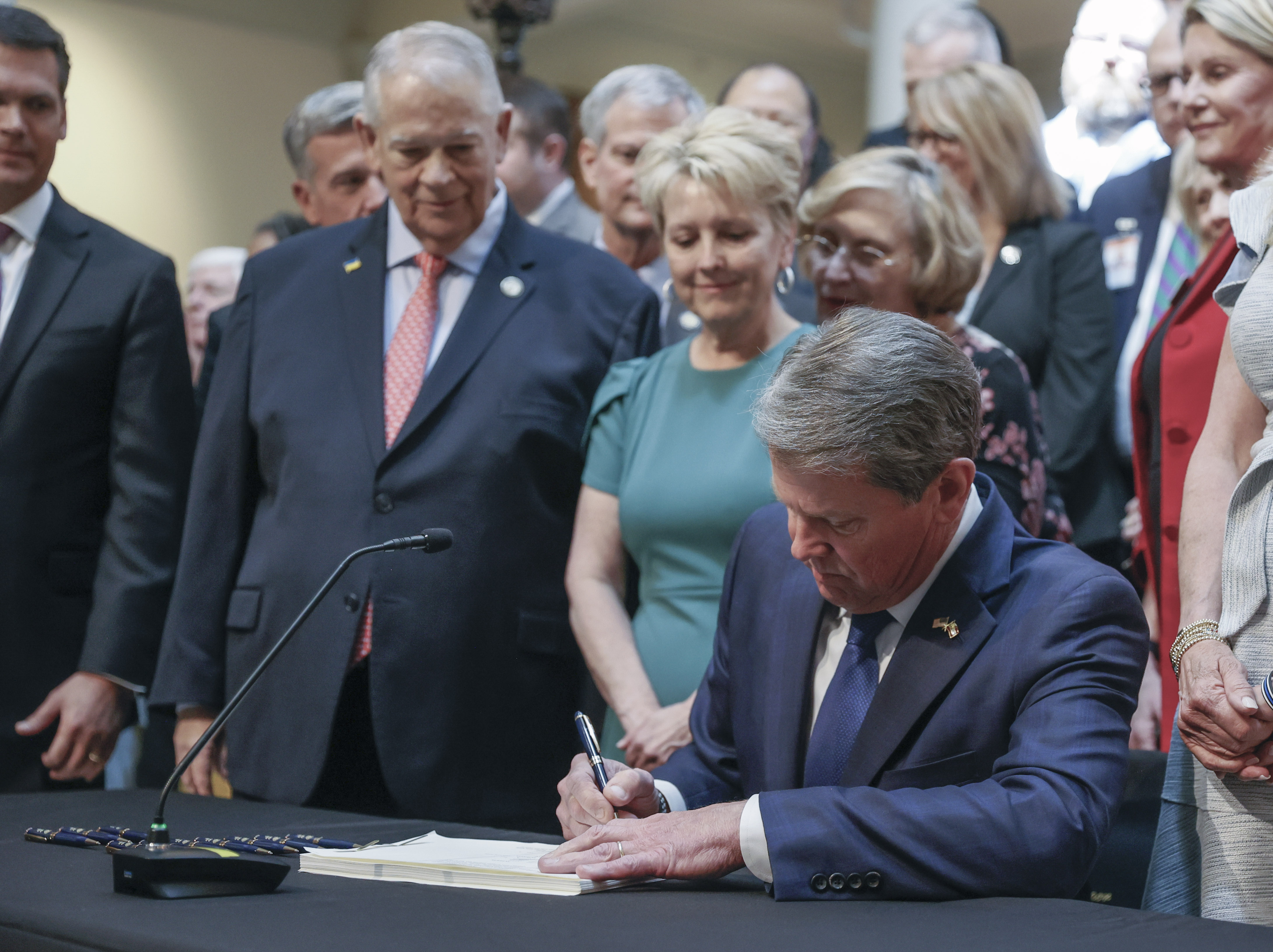 With much fanfare, Gov. Brian Kemp signs HB 1013, which aims to increase access to mental health coverage in Georgia on Sine Die, the last day of the General Assembly at the Georgia State Capitol in Atlanta on Monday, April 4, 2022. (Bob Andres / robert.andres@ajc.com)