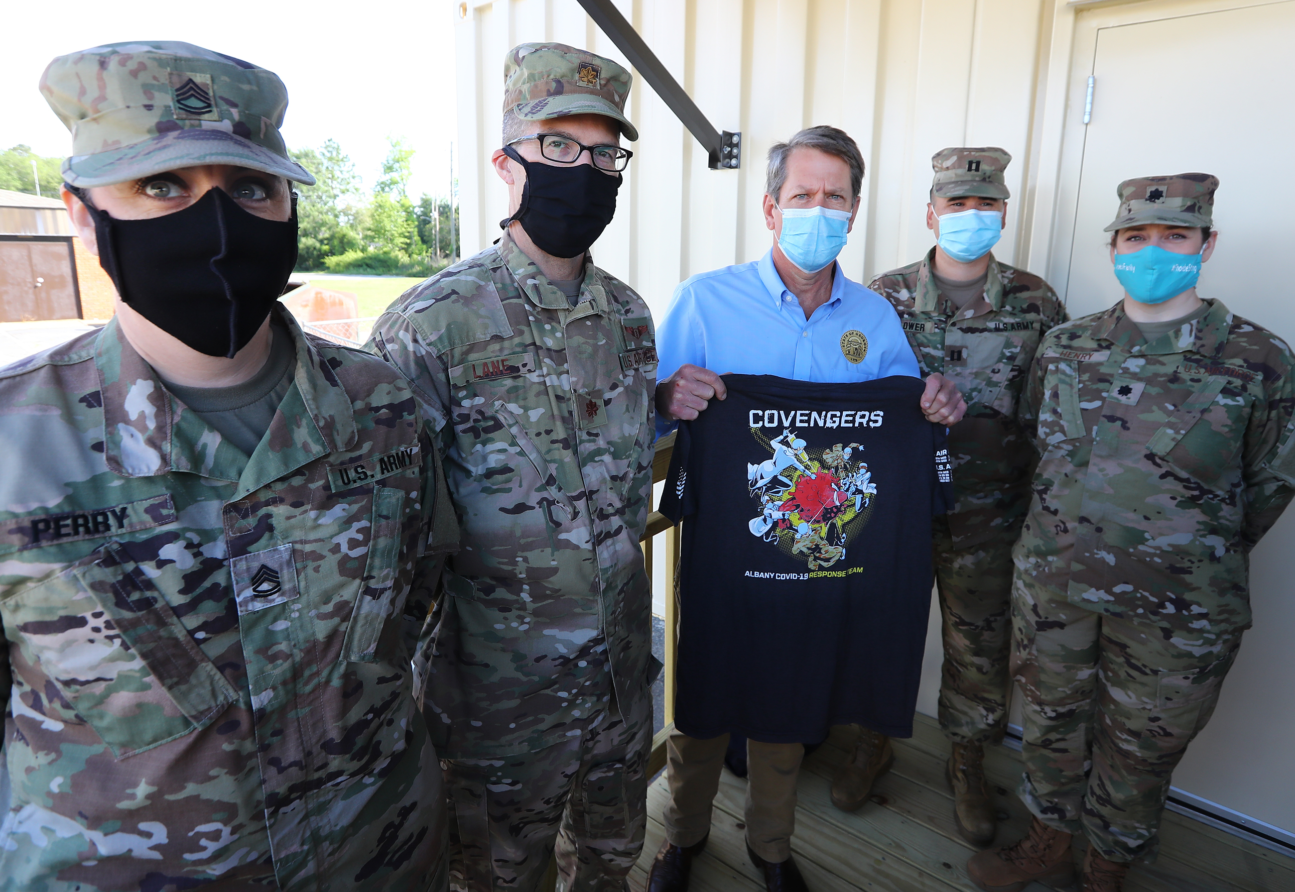 050520 Albany: Members of the Georgia Army National Guard and Georgia Air National Guard present Gov. Brian Kemp with a Covengers Albany COVID-19 Response Team shirt while he tours the temporary medical pod that has been placed at the Phoebe North Campus of Phoebe Putney Health System on Tuesday, May 5, 2020, in Albany. The pod at Phoebe North arrived on April 15 and is scheduled to begin operations on Wednesday, May 6, housing 24 beds to treat non-critical COVID-19 patients. Curtis Compton ccompton@ajc.com
