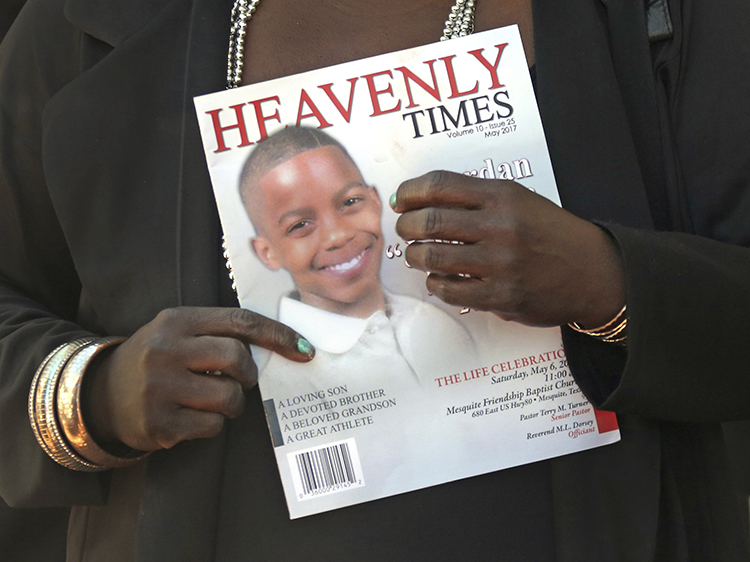 Mourners hold the commemorative program as they emerge from the funeral service for 15-year-old, Jordan Edwards, at Mesquite Friendship Baptist Church in Mesquite, Texas, Saturday, May 6, 2017. Roy Oliver, who has been fired from the Balch Springs Police Department, is free on bond after being arrested Friday in the April 29 shooting death of Edwards.