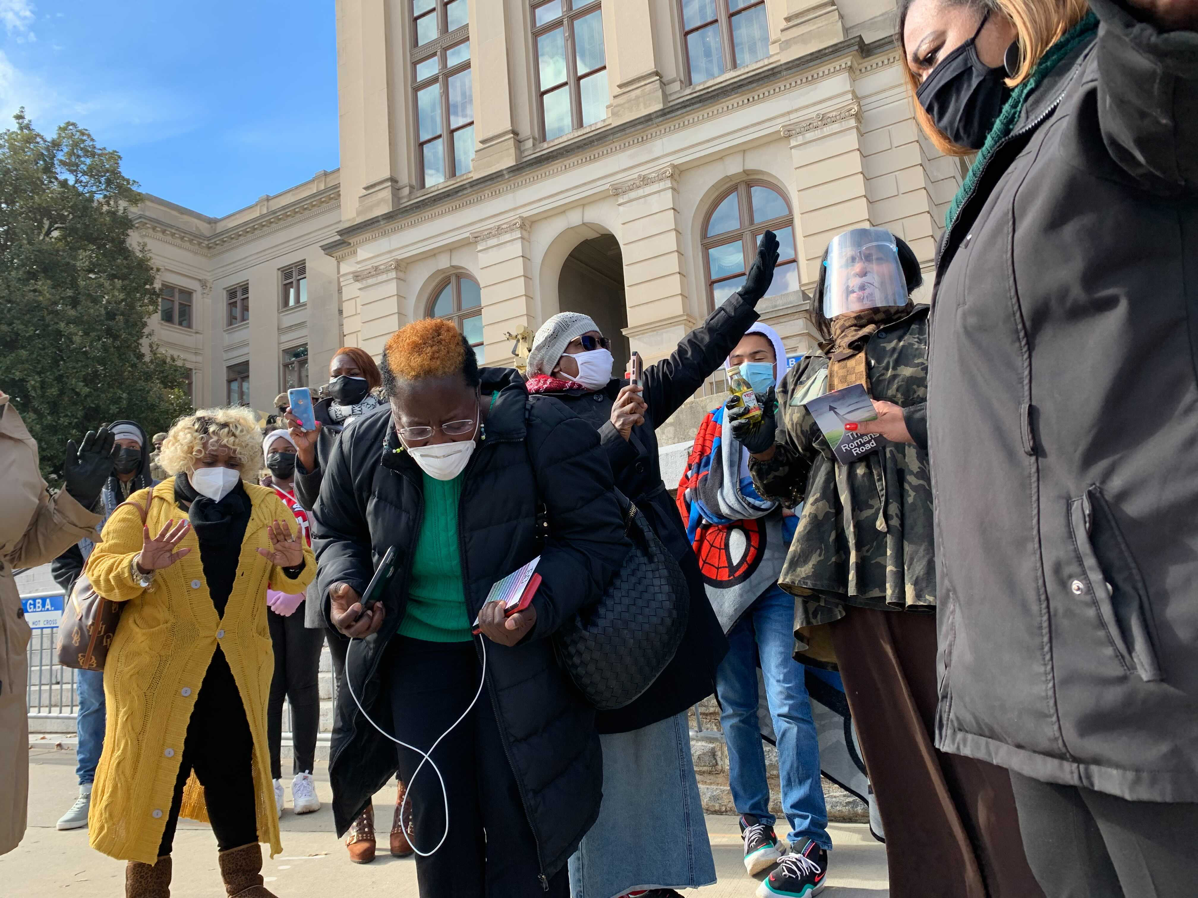 Jan. 17, 2021 — ATLANTA — More than a dozen worshippers from Divine Deliverance Life Center just outside of College Park prayed beside the state Capitol against more insurrections. (Jeremy Redmon / Jeremy.Redmon@ajc.com