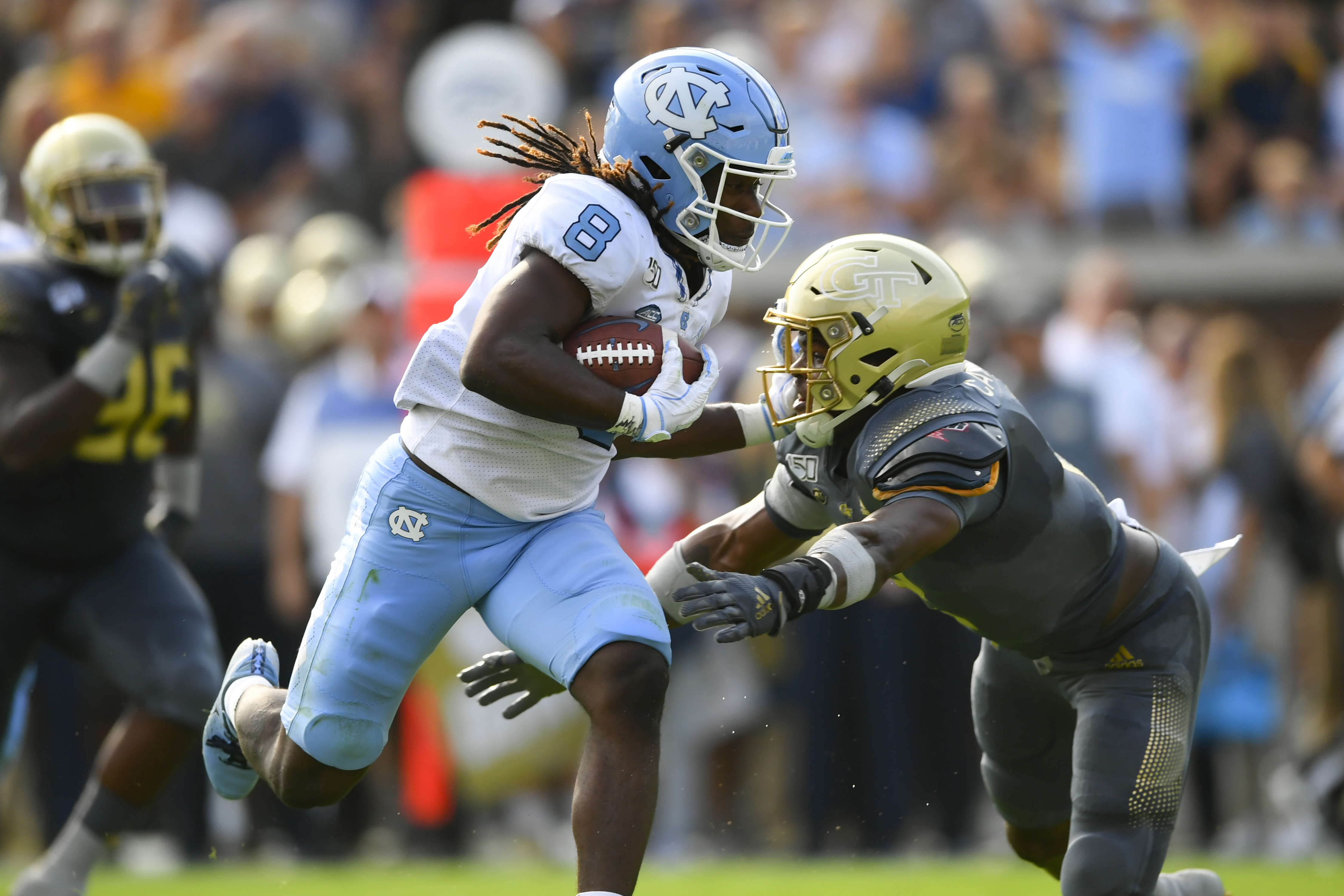 North Carolina running back Michael Carter (8) is tackled by Georgia Tech defensive back Tariq Carpenter Saturday, Oct. 5, 2019, in Atlanta. North Carolina won 38-22. (John Amis/For the AJC)