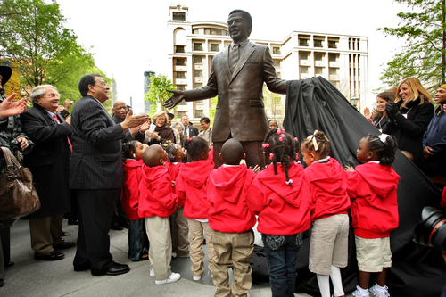 Charlie Loudermilk (left) applauds at the unveiling of the statue of Andrew Young in downtown Atlanta. The unlikely duo - Loudermilk was conservative Republican and Young a Democratic civil rights activist and politician - were close friends and allies. Loudermilk brought business support behind Young's campaigns and also paid for the statue.