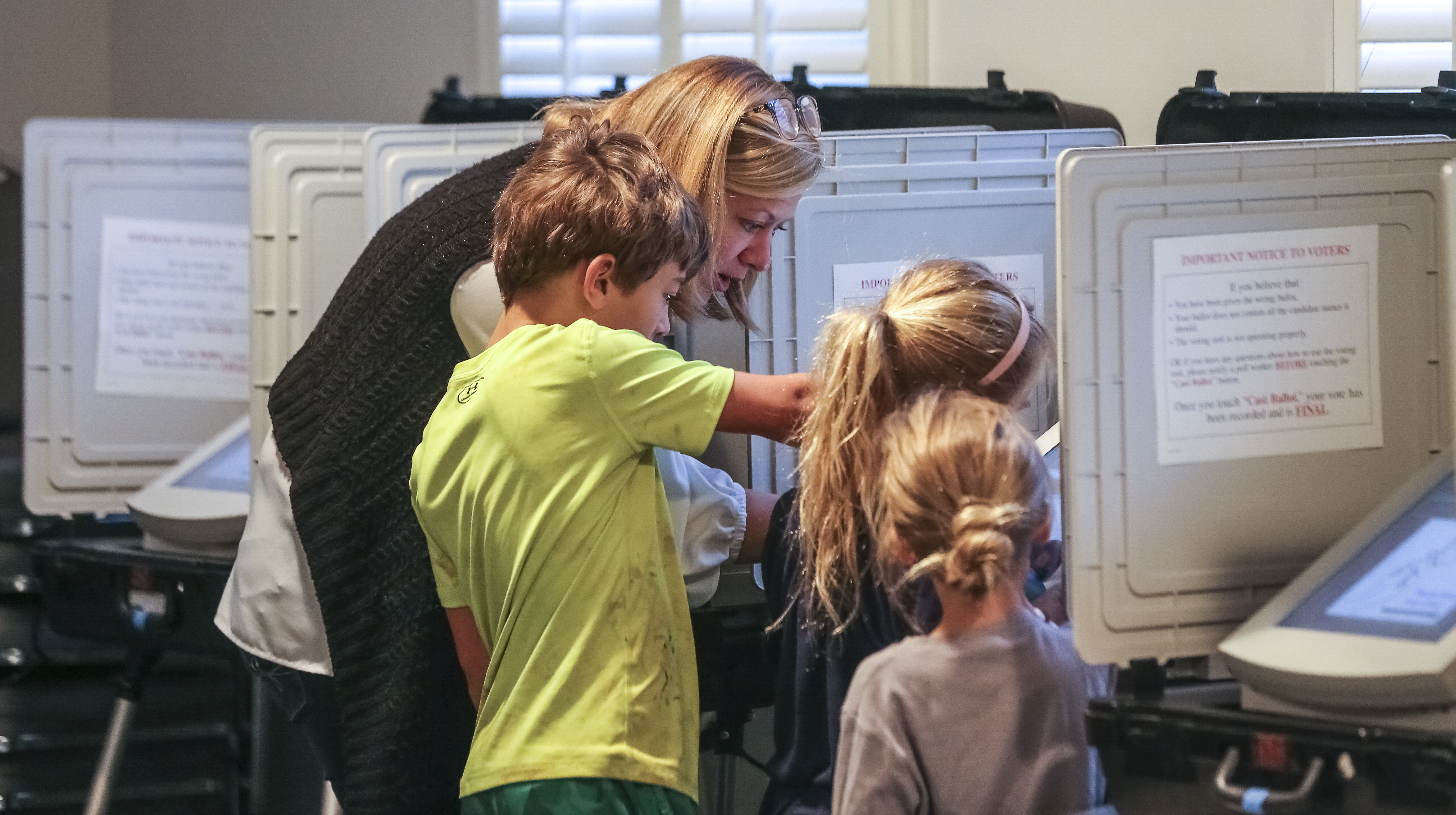 November 5, 2019 DeKalb County: Sarah Jones votes with her children, Left to Right - Noah-9,Elise-6 and Anna-6 at The Gathering at the Church at Decatur Heights polling place at 735 Sycamore Drive in Decatur on Tuesday, Nov. 5, 2019. The county of DeKalb voted on a referendum that would restructure the county's ethics board after the Georgia Supreme Court ruled that the way its members are currently appointed is unconstitutional. Critics of the proposal say the restructuring would weaken the ethics board and reduce some of its powers. Every city in DeKalb also had municipal elections for mayor or city council this fall with several incumbent mayors are facing challengers. There were scores of mayoral and city council seats up for grab JOHN SPINK/JSPINK@AJC.COM