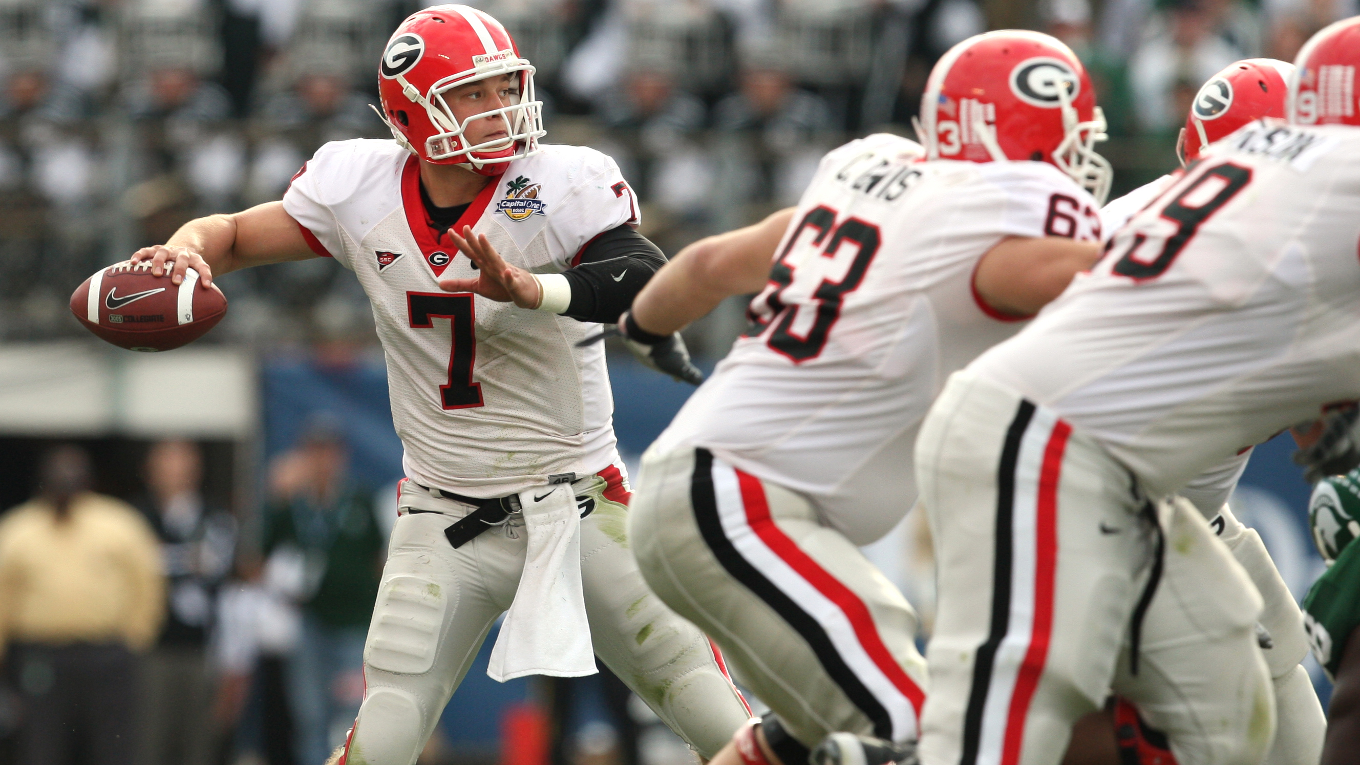 Georgia quarterback Matthew Stafford holds up his Detroit Lions