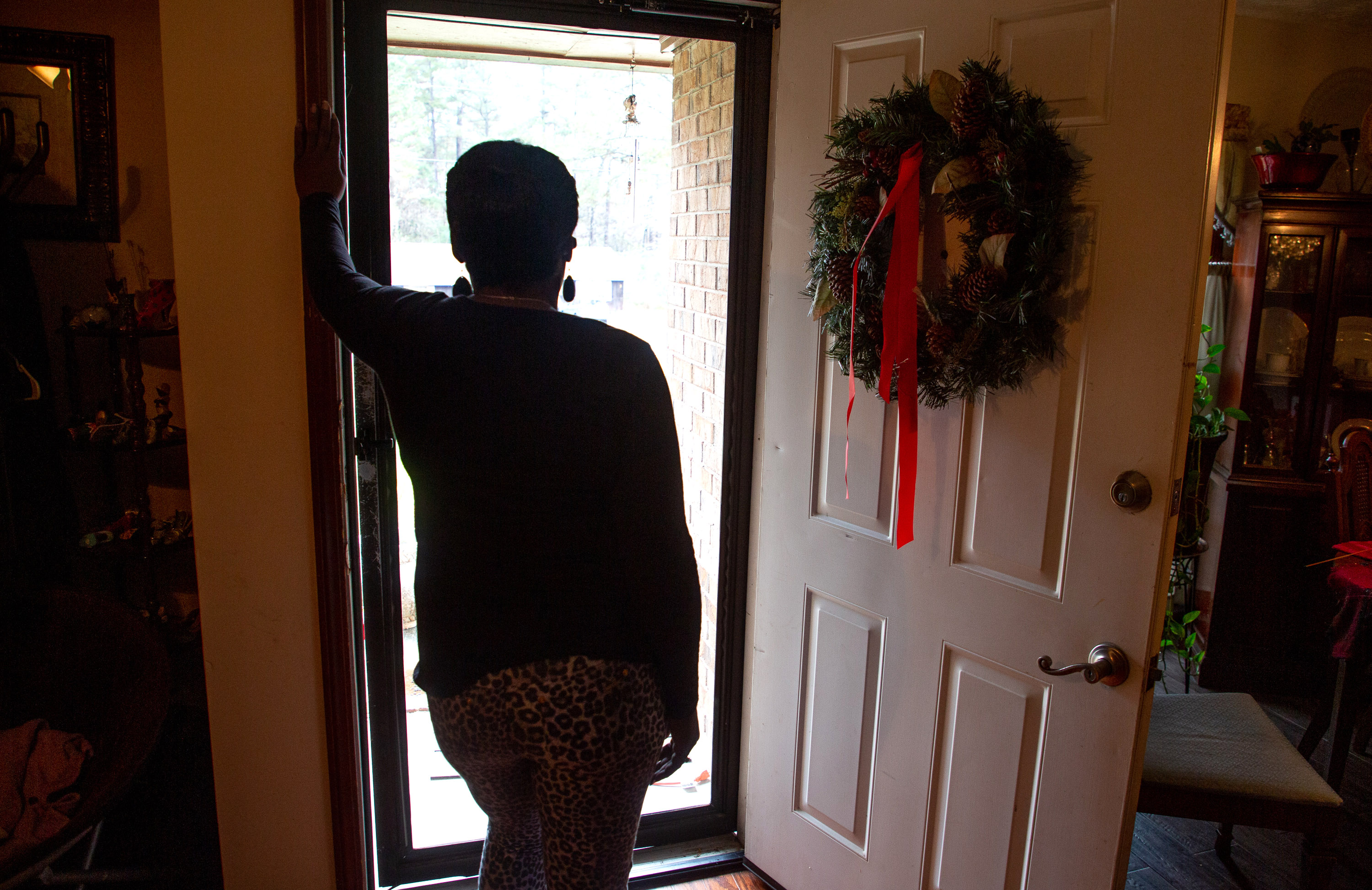 A client of the federal Housing Opportunities for Persons with AIDS program looks out the front door of the Ellenwood house where she was staying on Sunday, December 23, 2021. She is homeless after her case fell through the cracks of the city of Atlanta-run program. STEVE SCHAEFER FOR THE ATLANTA JOURNAL-CONSTITUTION