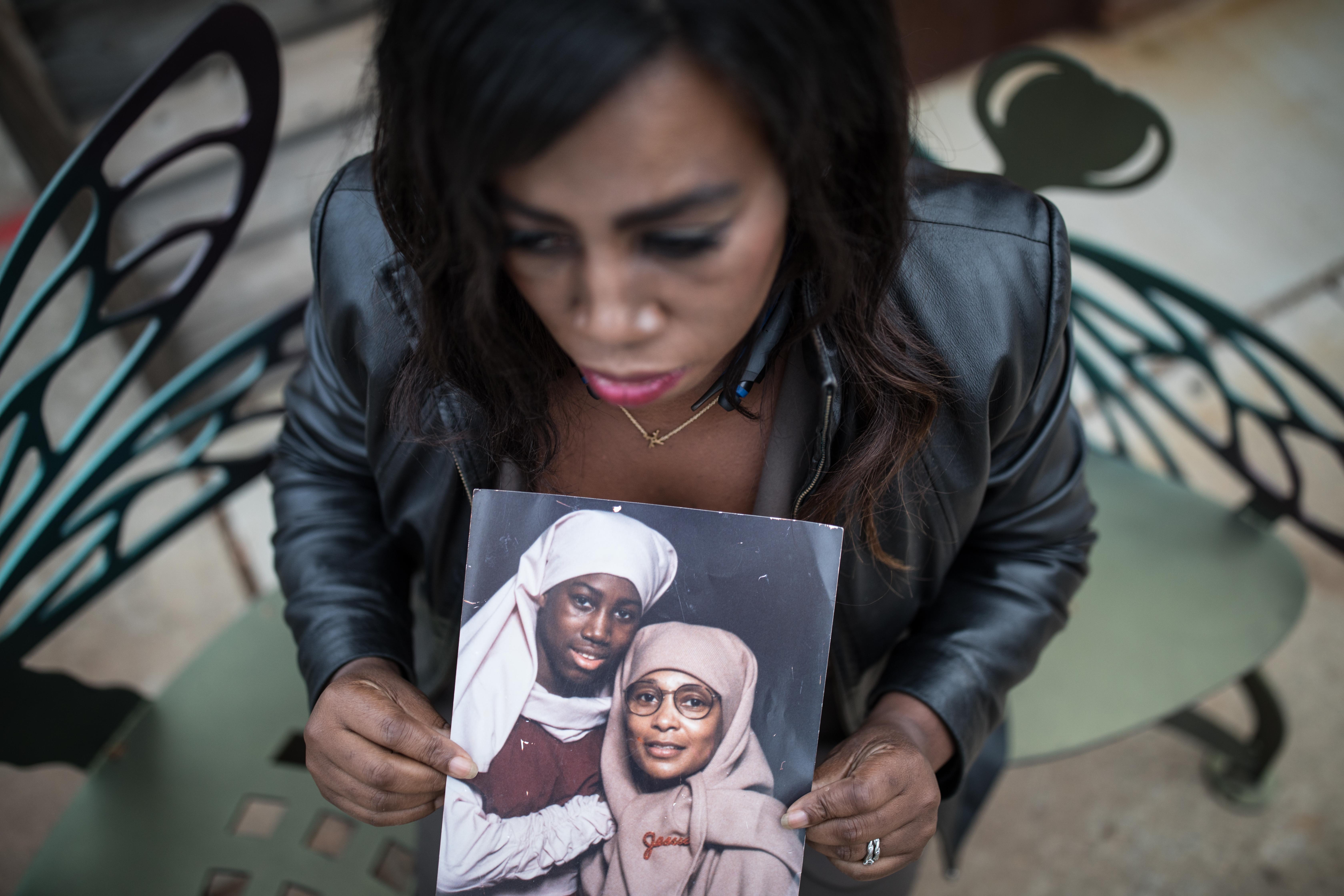 Joy Fluker poses for a portrait holding a photo of her and her mother, Anna Elizabeth Young, who was arrested for killing a young boy in Florida, Thursday, Dec. 7, 2017, in Woodstock, Ga. BRANDEN CAMP/SPECIAL