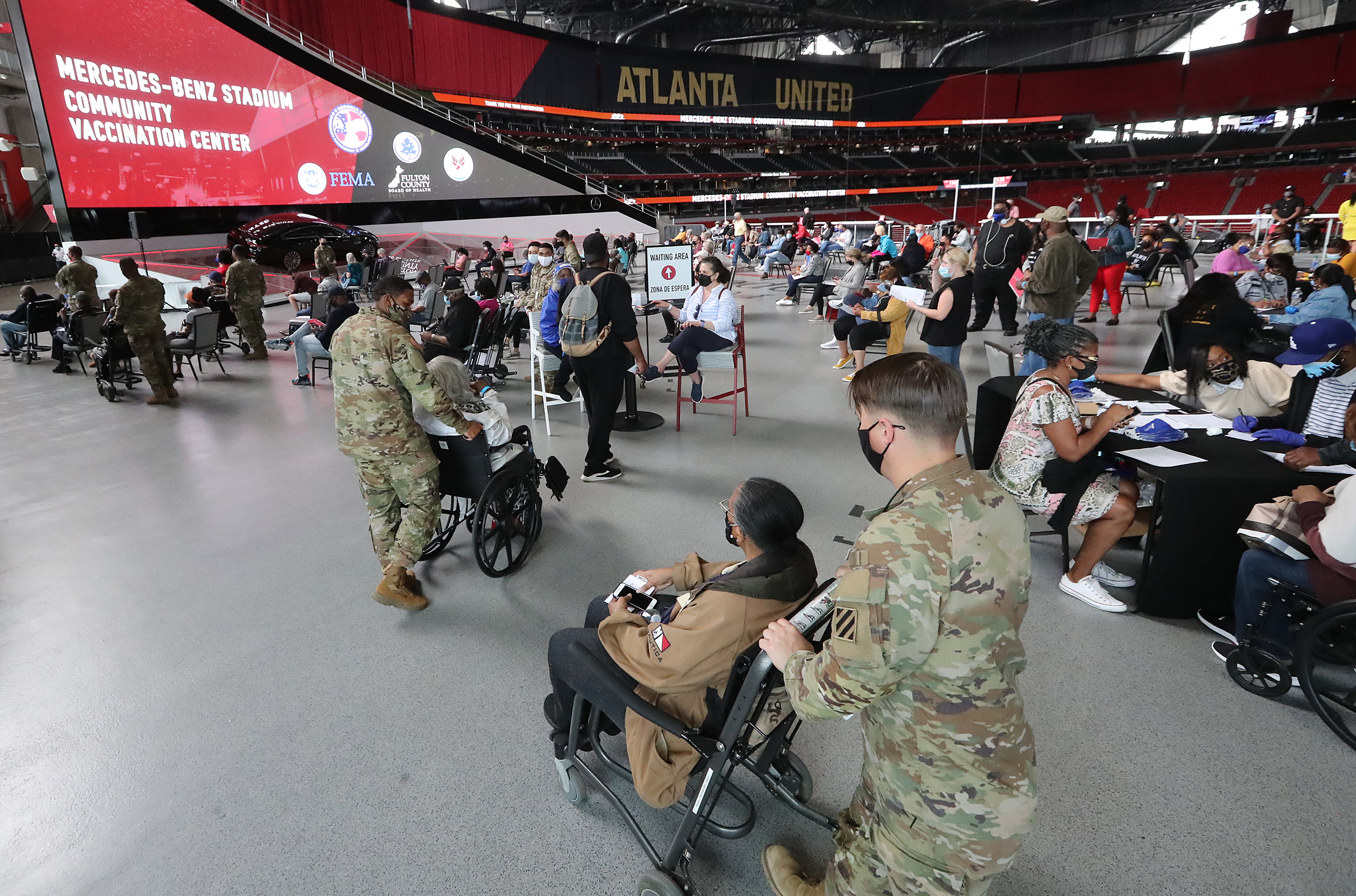 032421 Atlanta: U.S. Army soldiers from Fort Stewart help some of the elderly through the process of getting their first vaccination at Mercedes-Benz Stadium, the state’s largest Community Vaccination Center on Wednesday, March 24, 2021, in Atlanta. “Curtis Compton / Curtis.Compton@ajc.com”