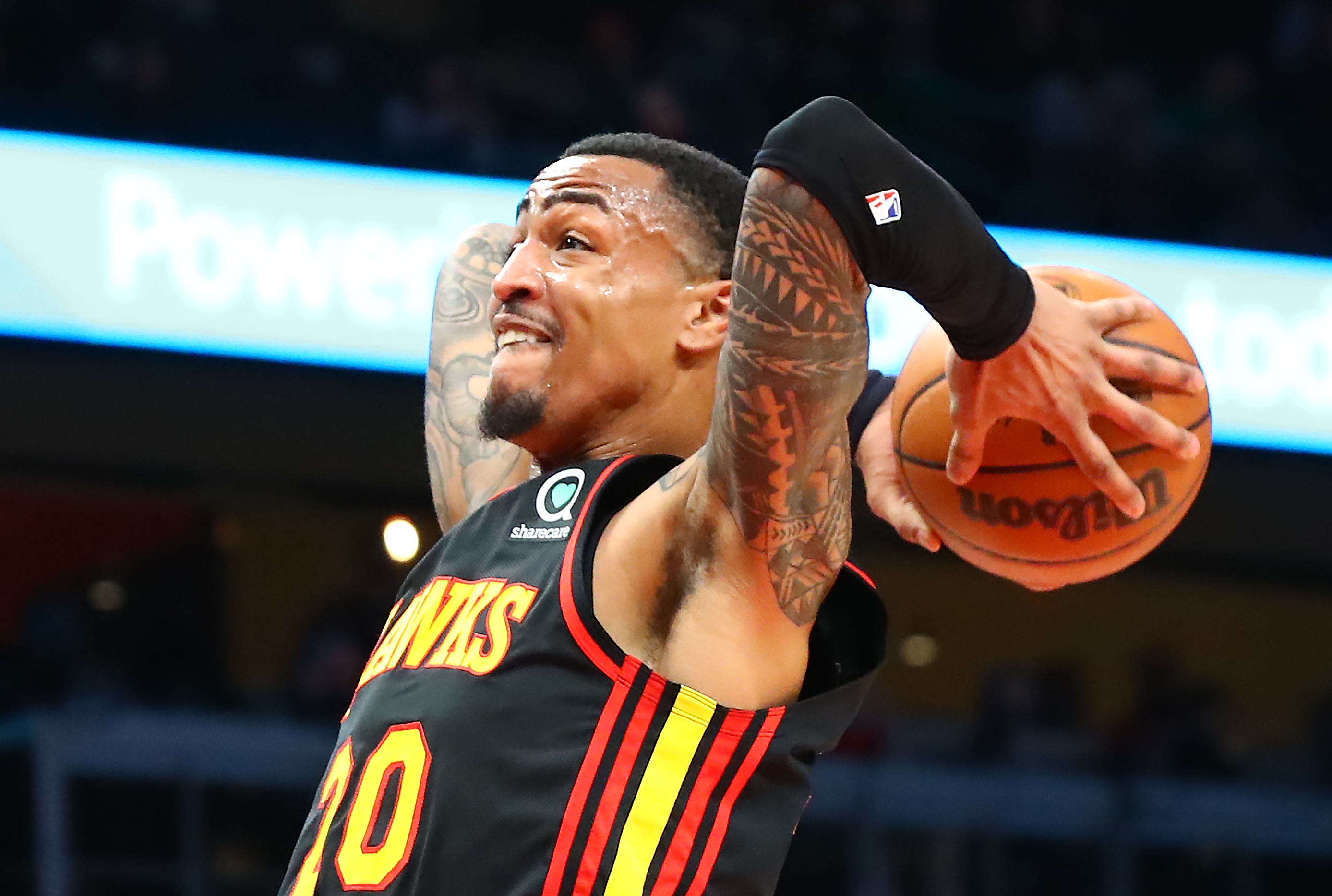 Atlanta Hawks forward John Collins jumps to the basket during the first period of an NBA basketball game to slam against the Indiana Pacers on Tuesday, February 8, 2022 in Atlanta.  Curtis Compton / Curtis.Compton@ajc.com
