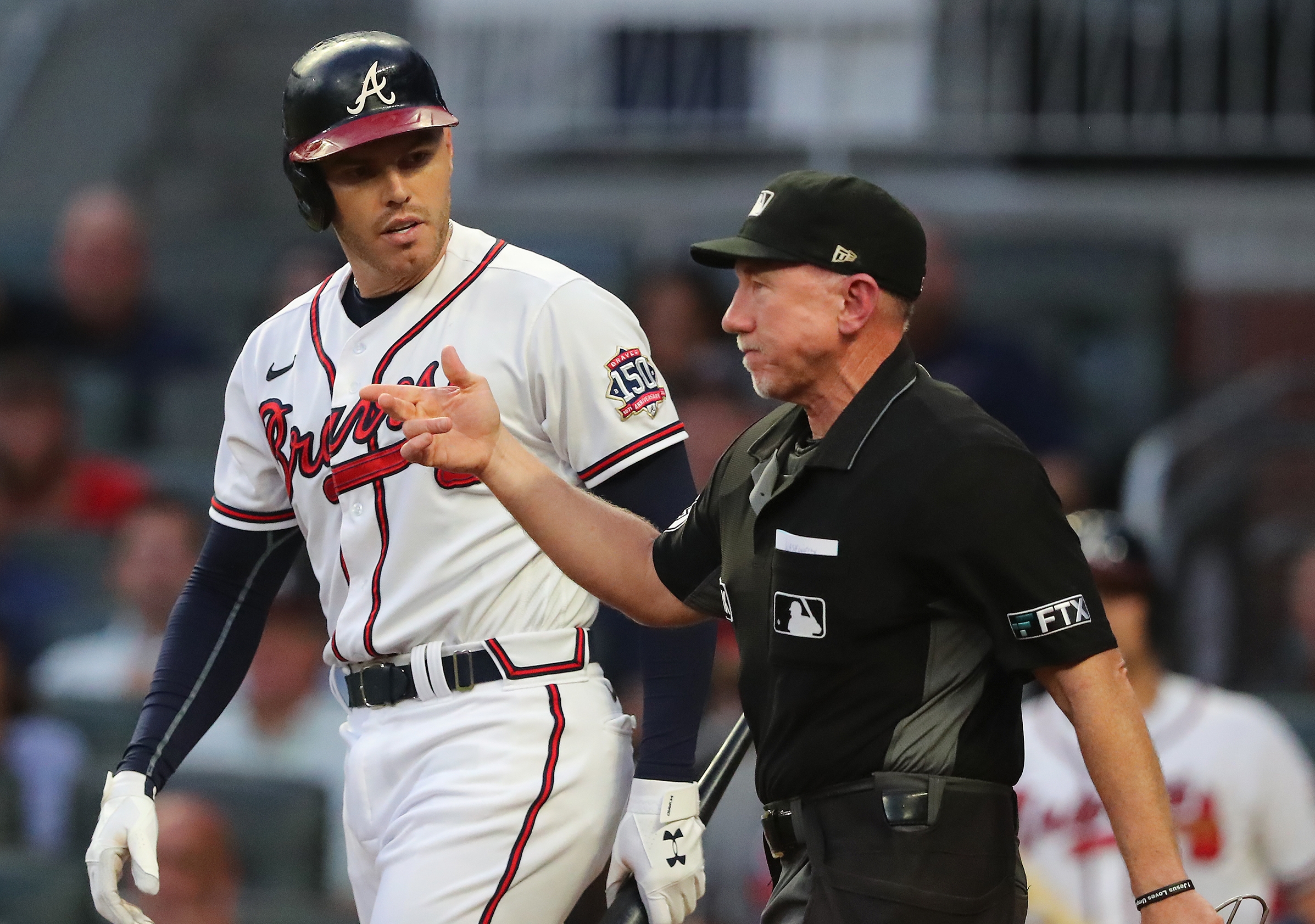 May 08, 2021: Atlanta Braves first baseman Freddie Freeman adjusts his hat  as he runs onto the field before the start of the ninth inning of a MLB  game against the Philadelphia