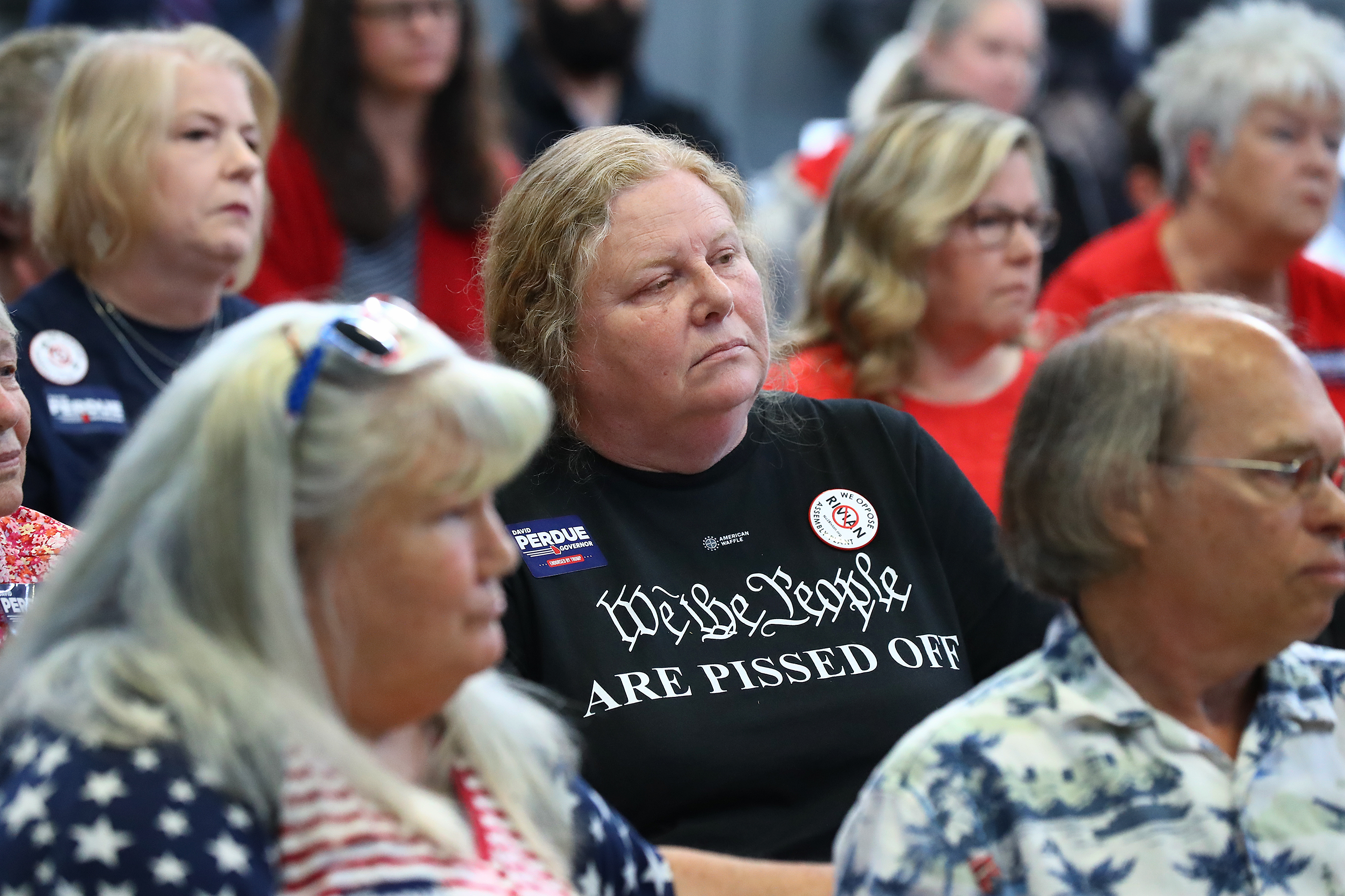 Rivian opponent Marcia Stephens, Rutledge, center, listens intently while the Site Design and Environmental committee takes public comments concerning the planned $5 billion Rivian electric vehicle plant on Monday, April 18, 2022, in Monroe. “Curtis Compton / Curtis.Compton@ajc.com”