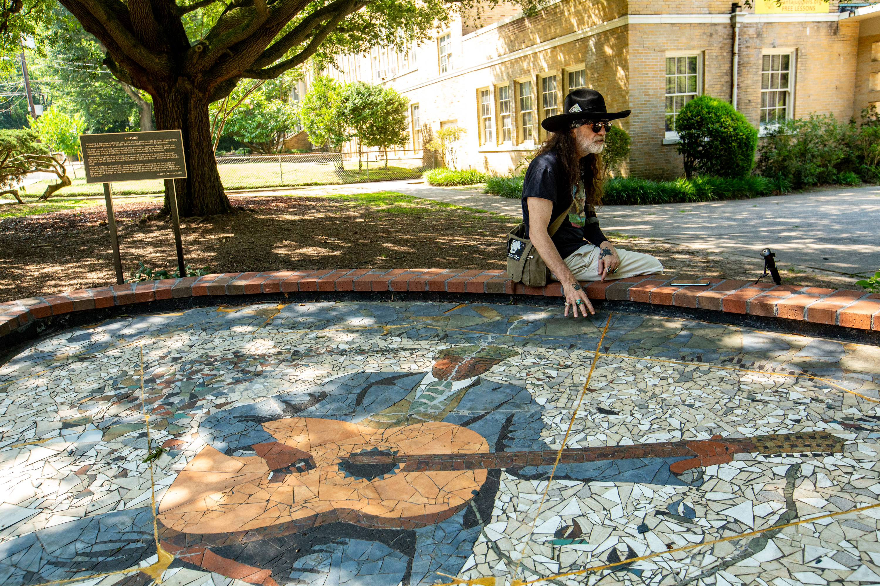 The Japanese art of kintsugi refers to a technique of repairing porcelain and pottery in which the breaks aren't disguised but instead are highlighted with powdered gold, silver or platinum. Artist Jason Evers Johnson adapted that concept to a larger scale project: breaking his monumental mosaic of Blind Willie McTell into pieces and moving it to the Little Five Points Community Center. (Jenni Girtman for The Atlanta Journal-Constitution)