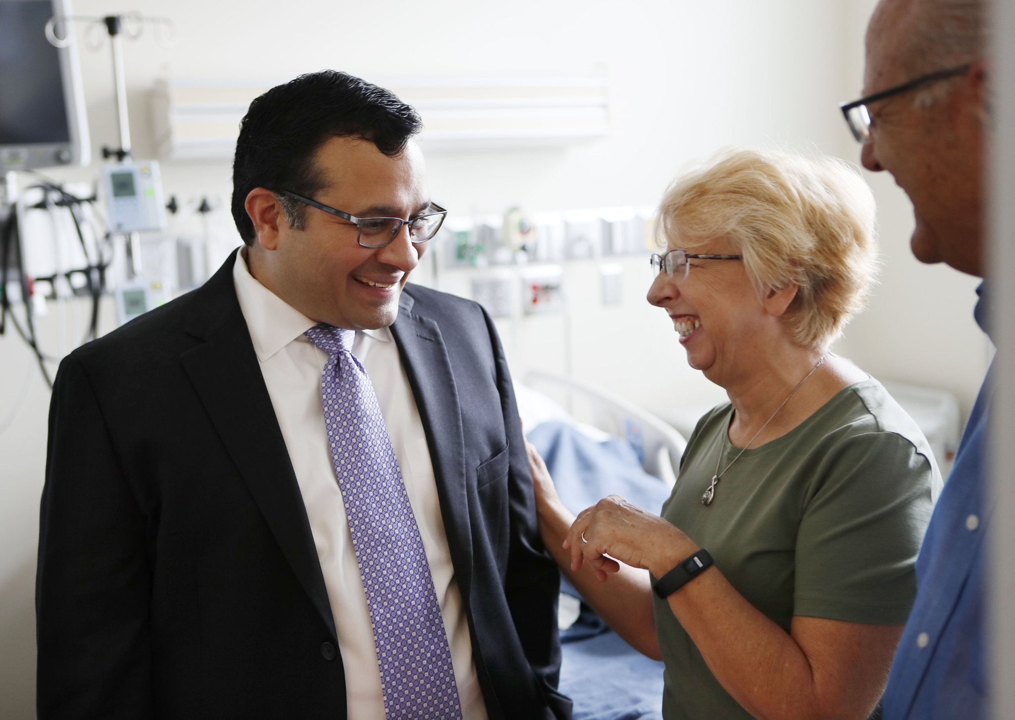 Dr. Aneesh Mehta (from left) speaks with Nancy Writebol and her husband, David, in the room in the Serious Communicable Diseases Unit where she was treated for Ebola in this August, 2, 2019 file photo. Mehta is an associate professor of medicine in Emory’s division of infectious diseases.