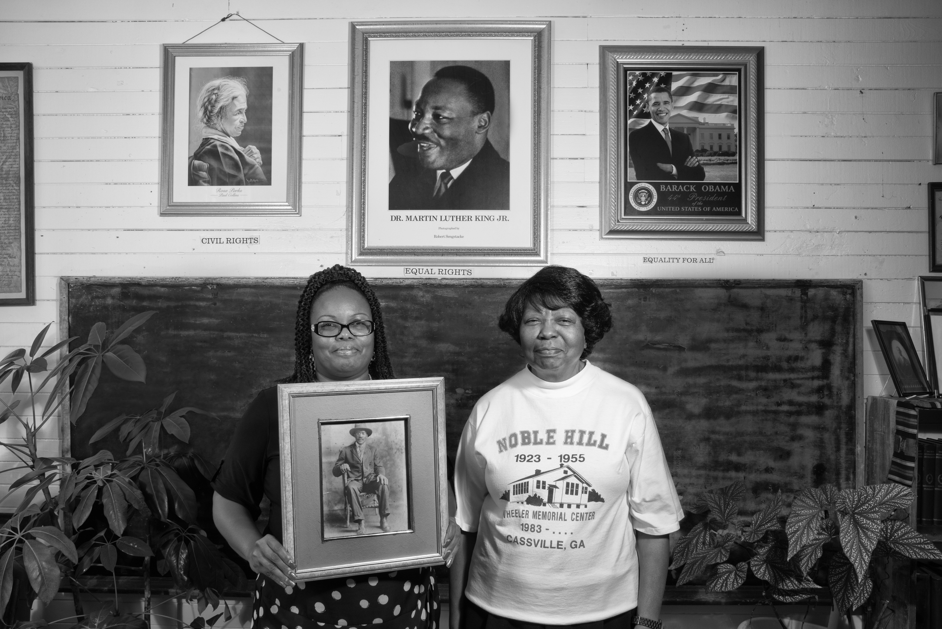 Valerie Coleman (left) and Marian Coleman hold a photo of their ancestor Webster Wheeler, who migrated to Detroit, but returned to Cassville, Ga., to help build the Noble Hill School. That school is now a cultural heritage center, curated by Valerie Coleman, great-great-granddaughter of Wheeler. Valerie's aunt, Marian Coleman, is one of the last graduates of Noble Hill. Photo: Andrew Feiler