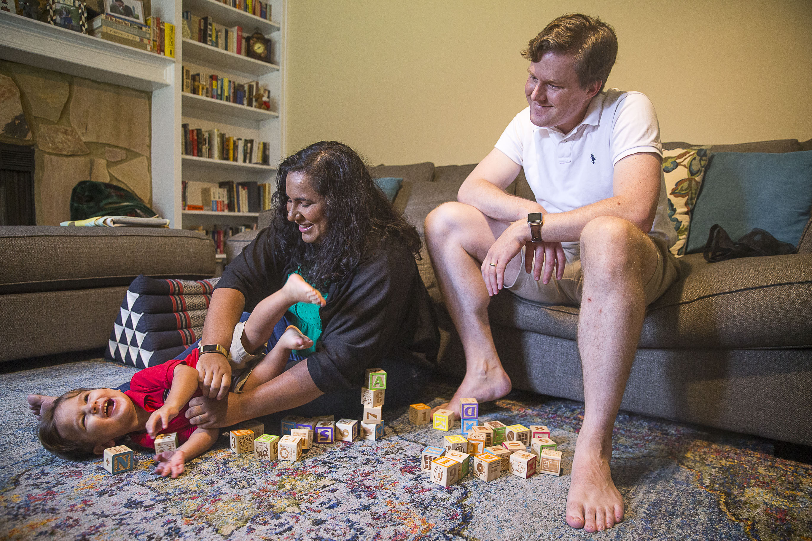 John Henry Theiss (right) watches his wife Sunita Theiss (center) plays with their son, John Sunil Theiss at their residence in Lawrenceville, Saturday, September 14, 2019. (Alyssa Pointer/alyssa.pointer@ajc.com)
