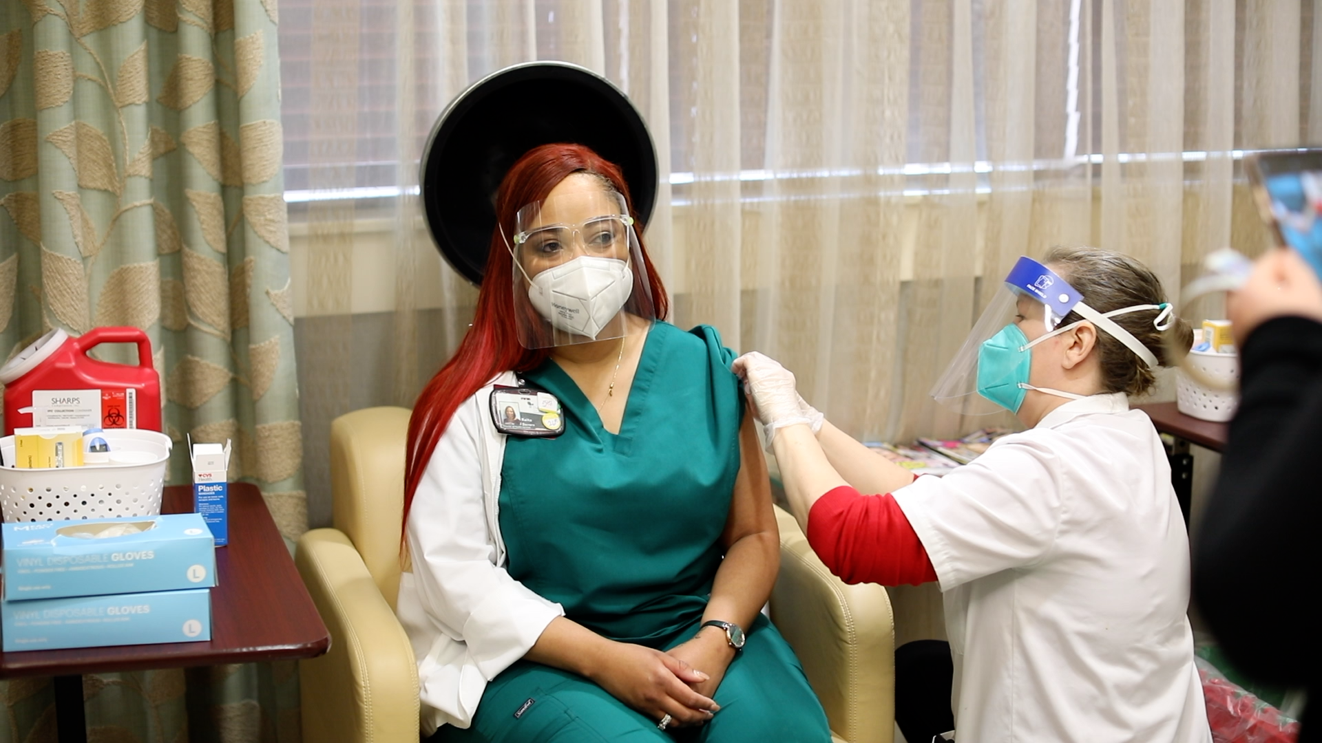 Keita Devero, Director of Nursing at The Oaks Athens nursing home, gets a shot of the COVID vaccine. Devero, who had already contracted the virus before getting her shot, has urged others in the home to get the vaccine. “I’m not gonna stop being the cheerleader for them becoming vaccinated,” she said. “I wouldn’t wish what I went through on anyone.”