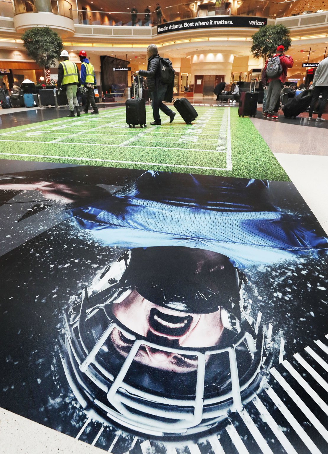 A gridiron is on the floor in the terminal atrium at Hartsfield-Jackson. Officials say the Super Bowl will mean a 30 percent spike in traffic at Hartsfield Jackson-International Airport, up from the 2,500 flights a day it usually handles.. Bob Andres / bandres@ajc.com
