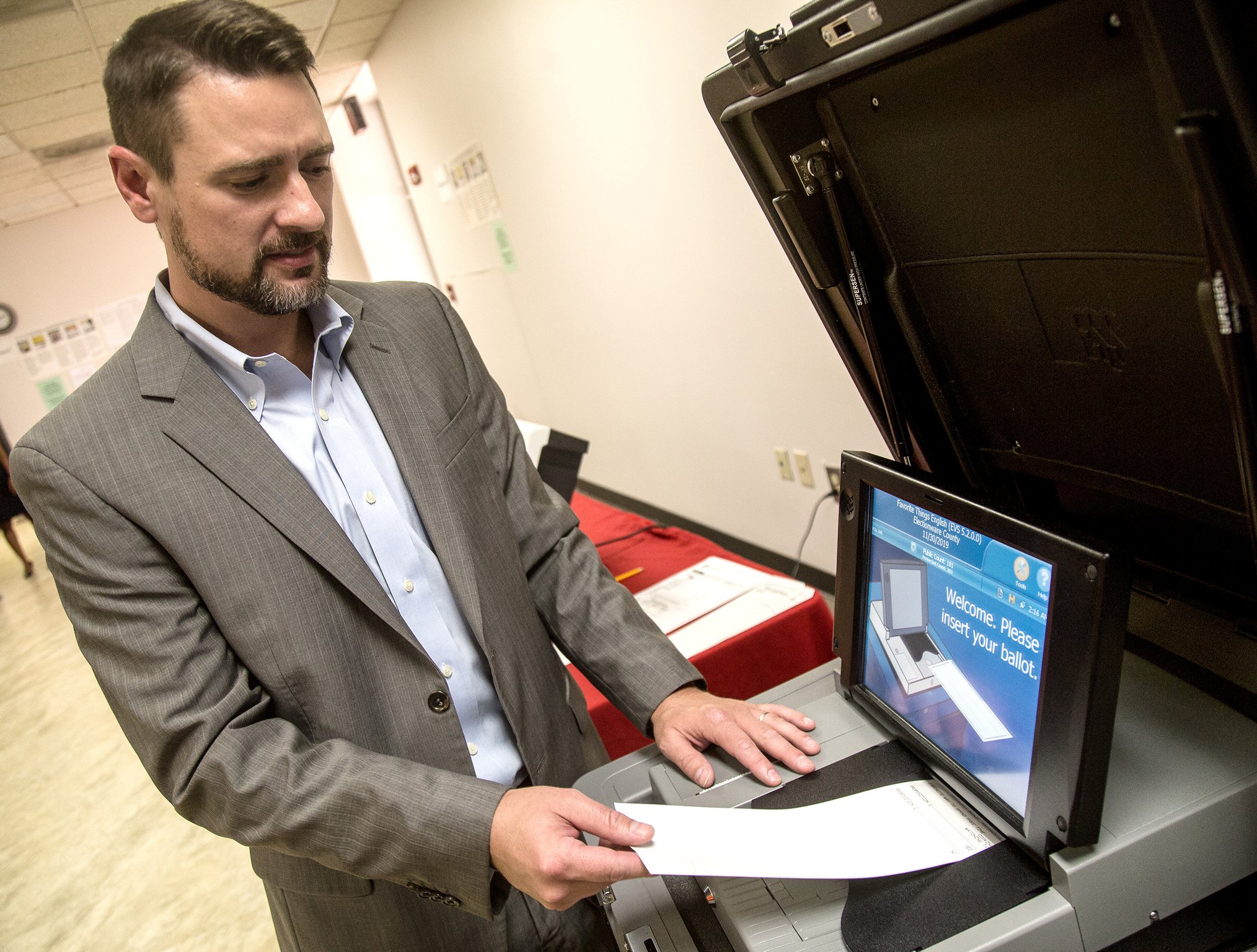 Jeb Cameron with Election Systems & Software demonstrates paper-ballot voting machines at the Rockdale County Board of Elections in Conyers on Sept. 5, 2017. STEVE SCHAEFER / SPECIAL TO THE AJC