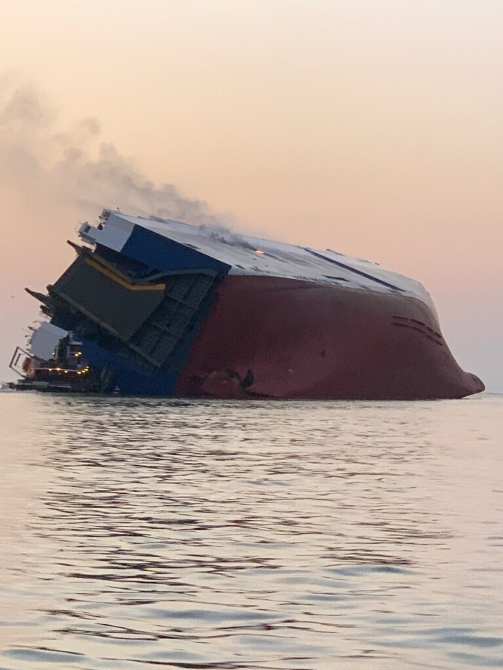 In this photo provided by the U.S. Coast Guard, the M/V Golden Ray cargo ship is shown capsized near St. Simons Island, Georgia.