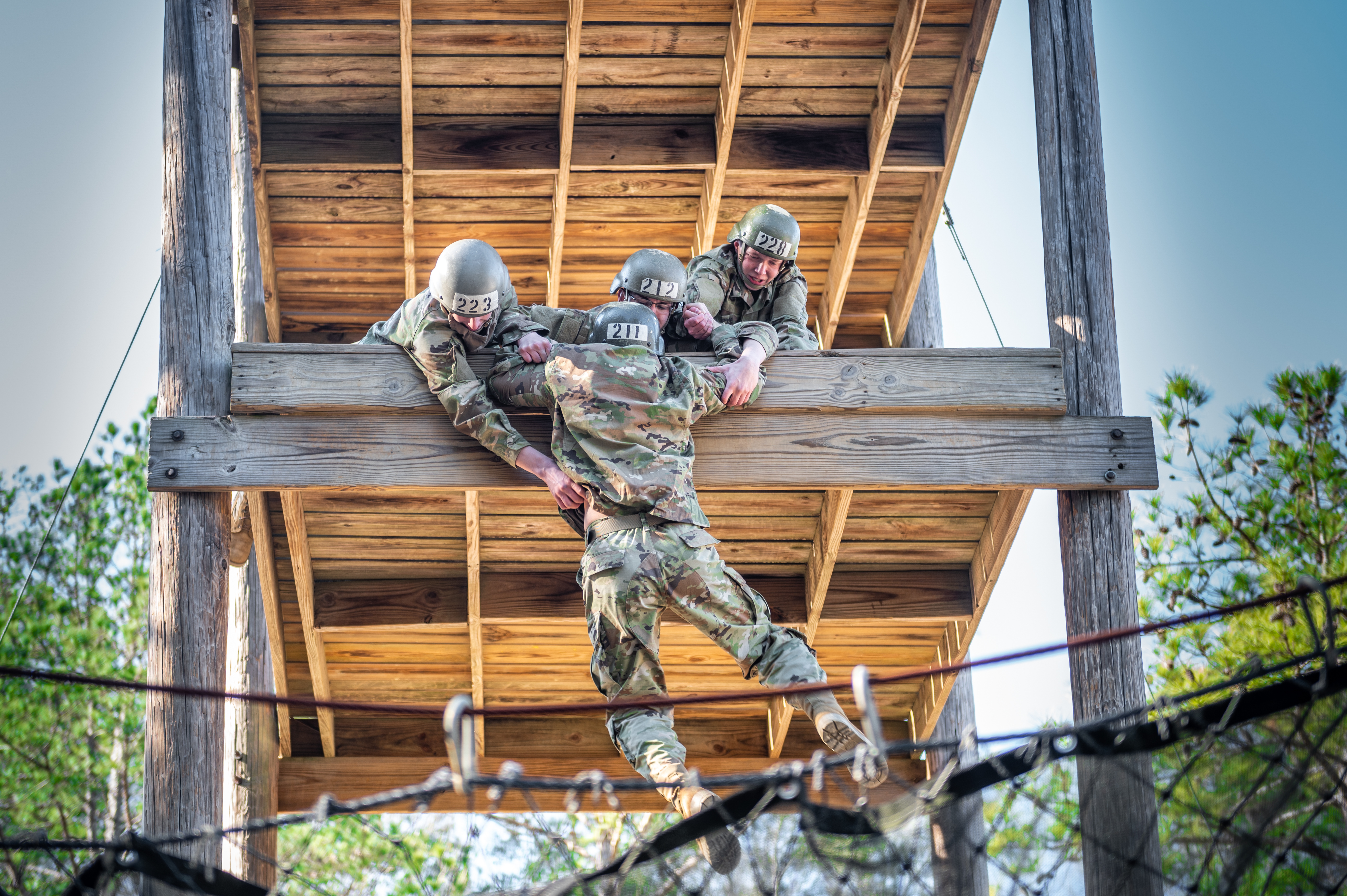 African American soldiers exhibit focus and strength in a rope