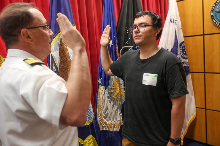 Navy Captain Rich Sussman administers enlistment oath to son on last day of service
