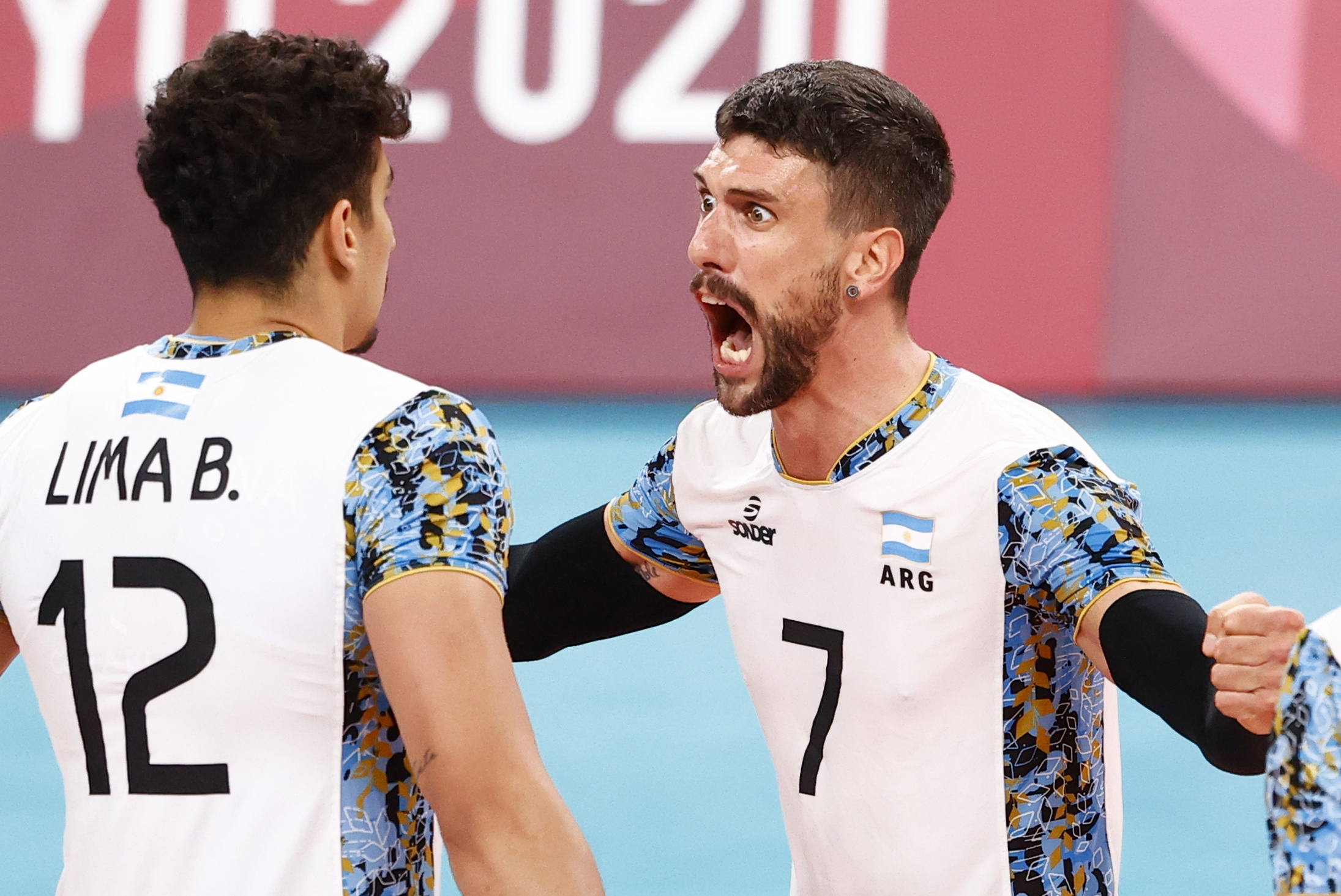 Tokyo 2020 Olympics - Volleyball - Men's Quarterfinal - Italy v Argentina - Ariake Arena, Tokyo, Japan - August 3, 2021. Bruno Lima of Argentina and Facundo Conte of Argentina celebrate. REUTERS/Carlos Garcia Rawlins