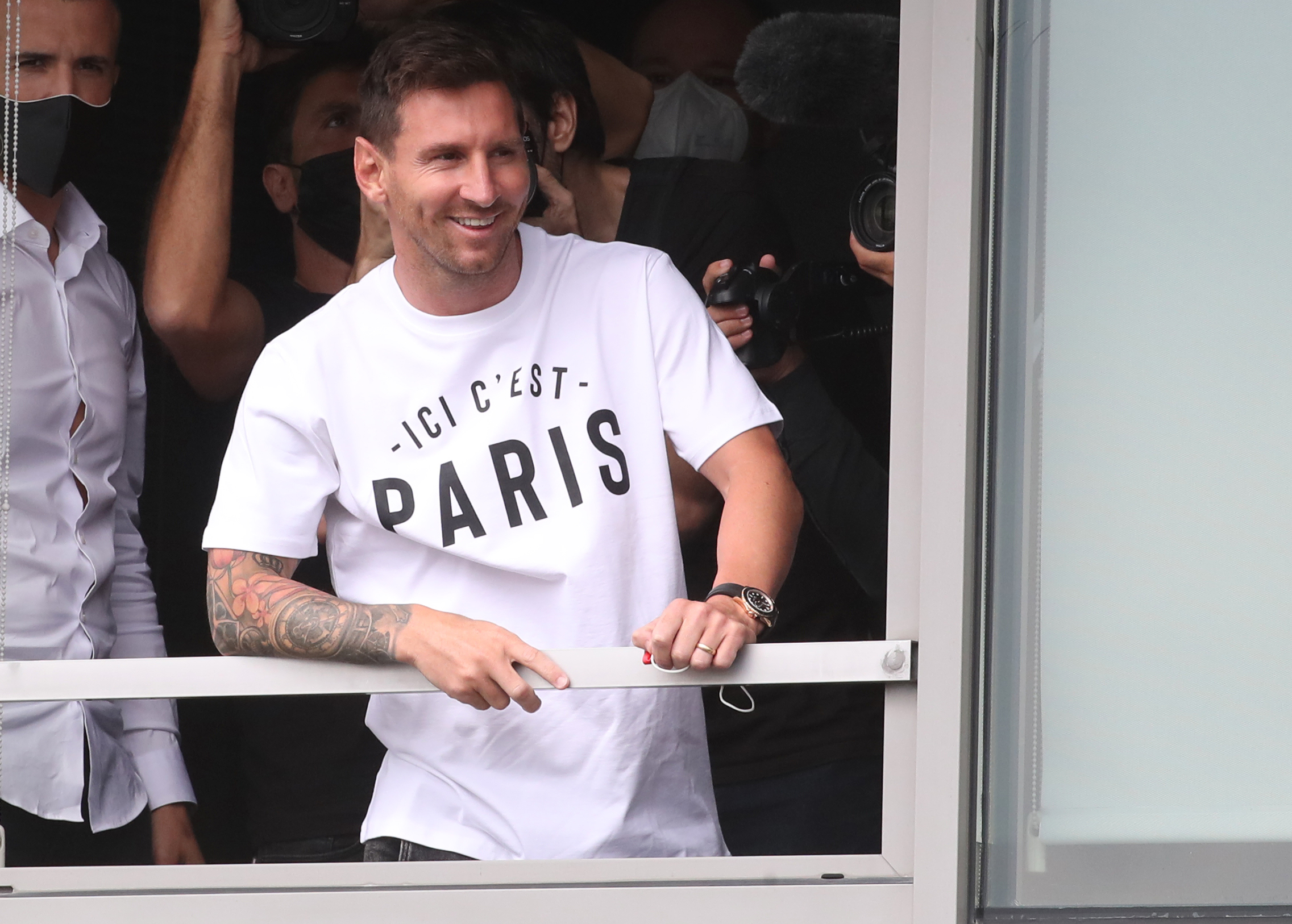 Soccer Football - Lionel Messi arrives in Paris to join Paris St Germain - Paris-Le Bourget Airport, Paris, France - August 10, 2021 Lionel Messi reacts as he arrives at Paris-Le Bourget Airport REUTERS/Yves Herman