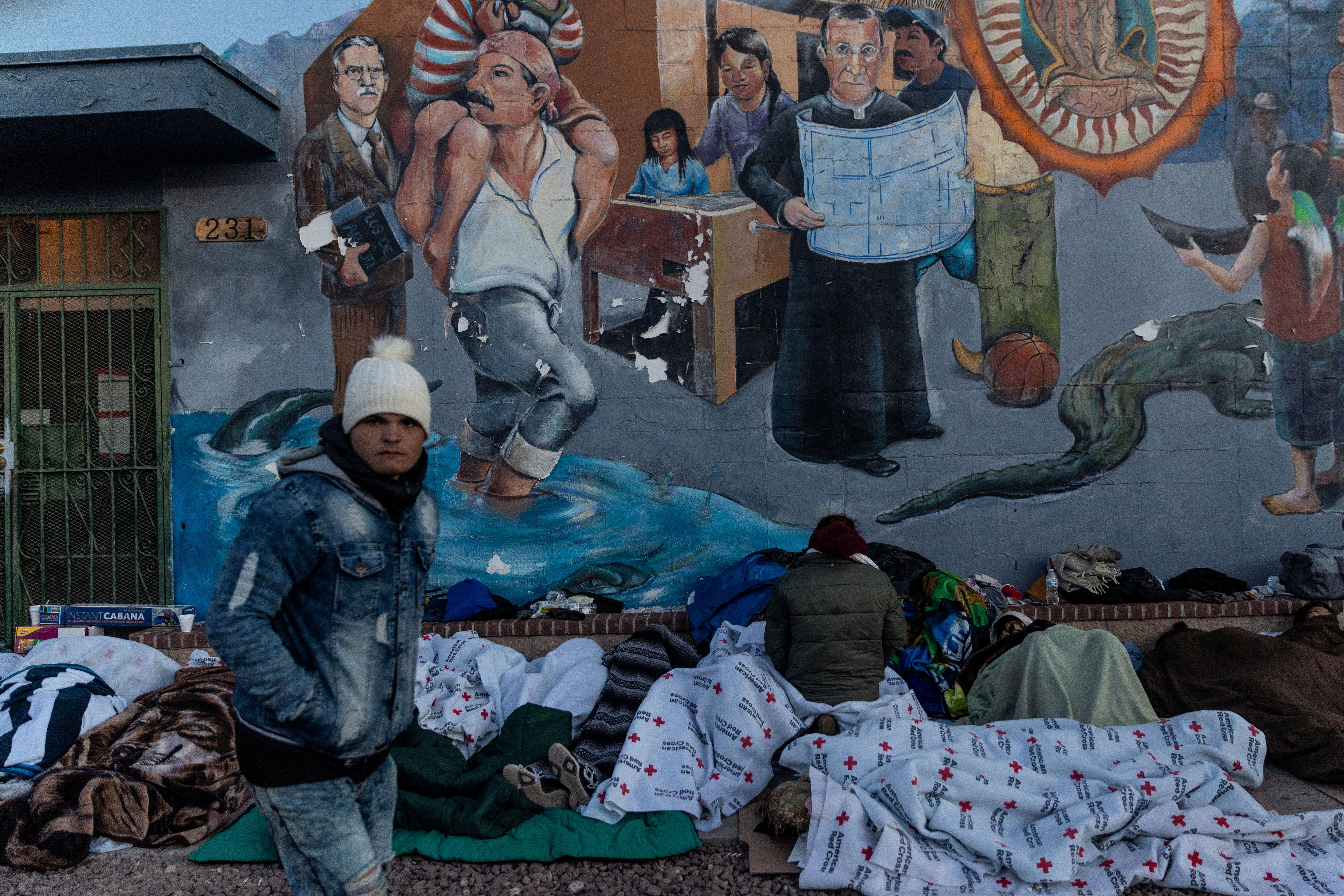 FILE PHOTO: A migrant asylum seeker walks outside the Sacred Heart Church after being released from U.S. Customs and Border Protection (CBP) custody and spending the night on the street in El Paso, Texas, U.S., December 21, 2022. REUTERS/Carlos Barria/File Photo