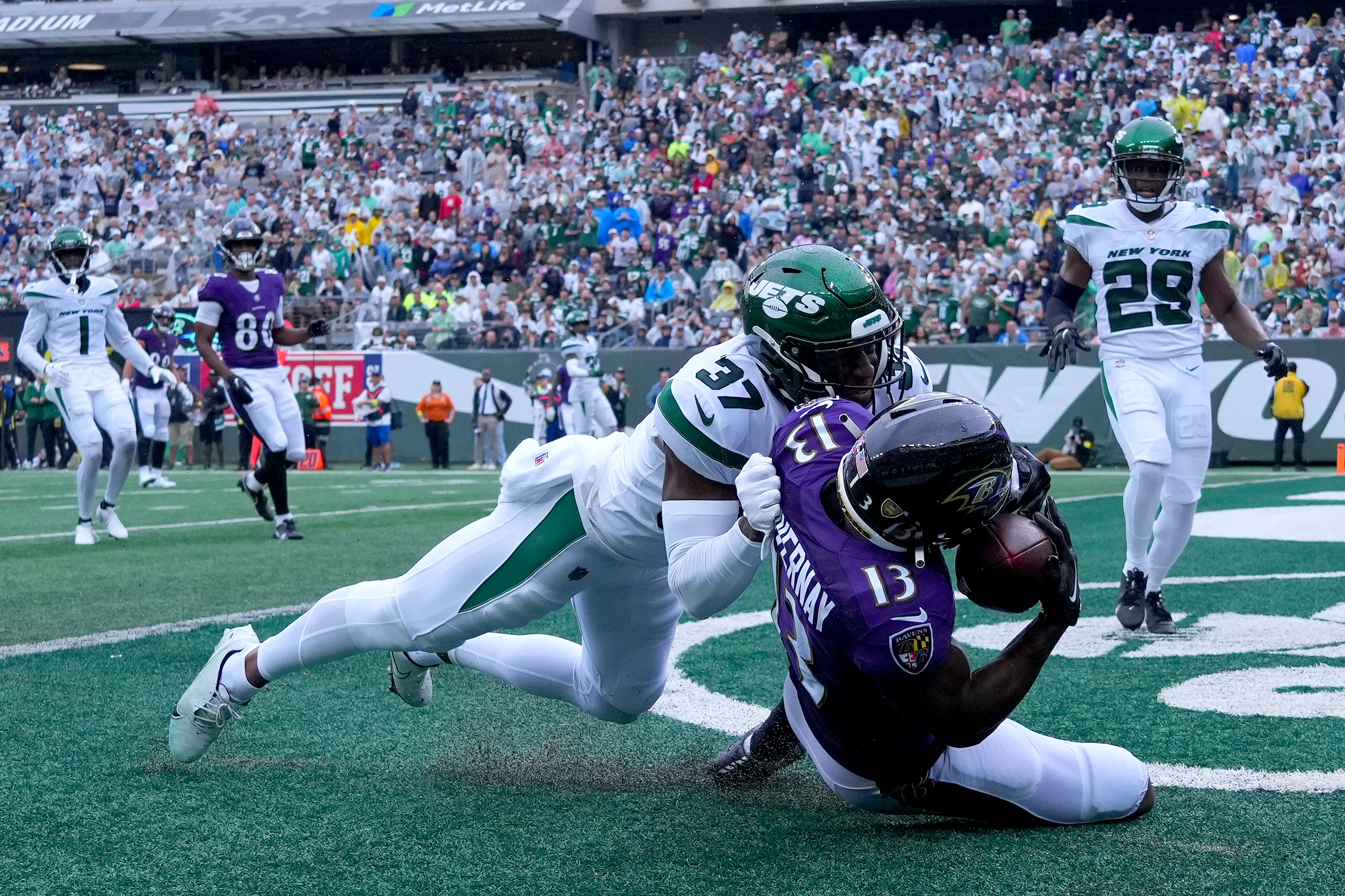 Corey Davis of the New York Jets is tackled by Brandon Stephens of News  Photo - Getty Images