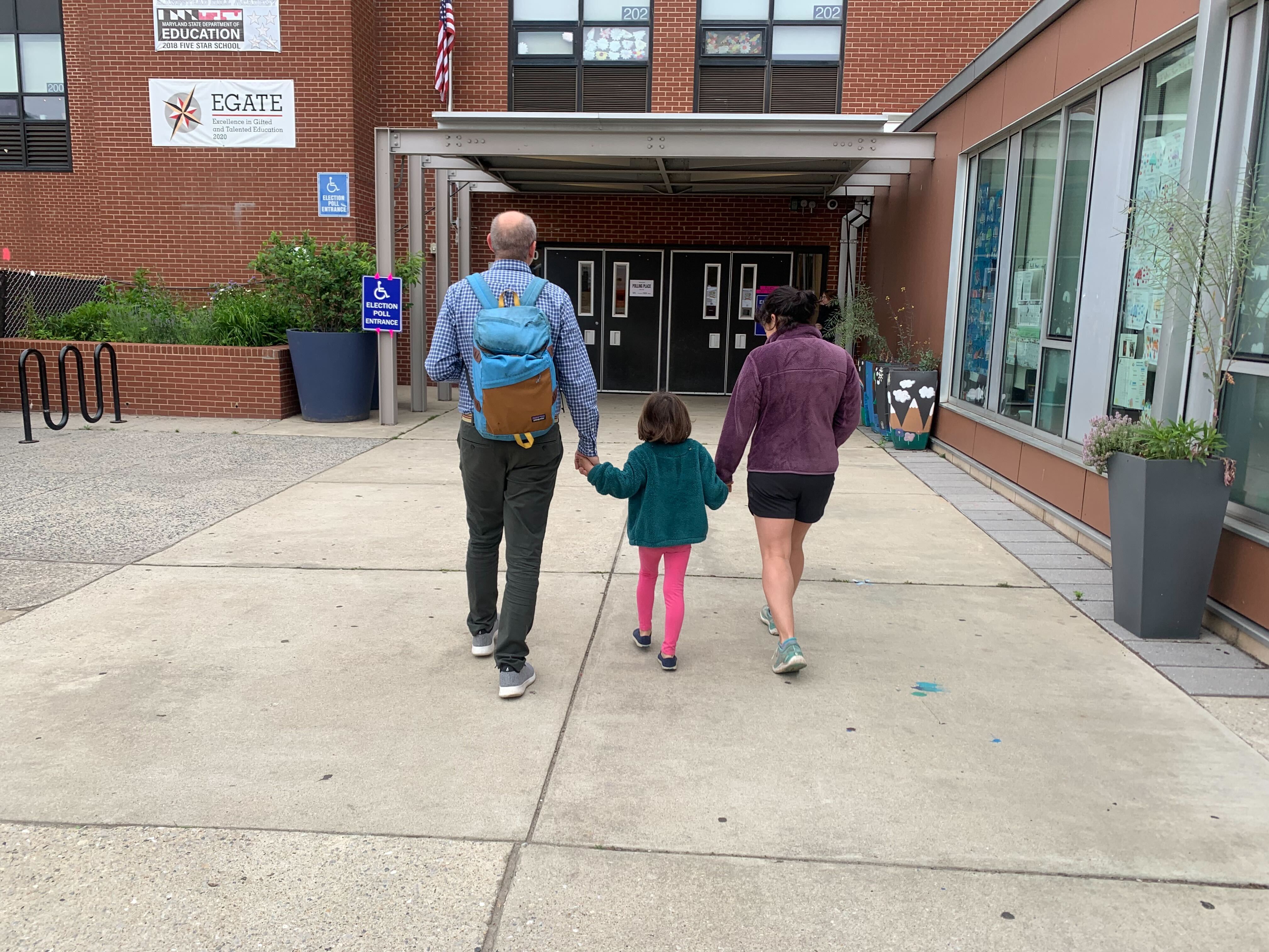 The Kronsberg family made their way to vote on Tuesday in Canton. (Brenna Smith/The Baltimore Banner)