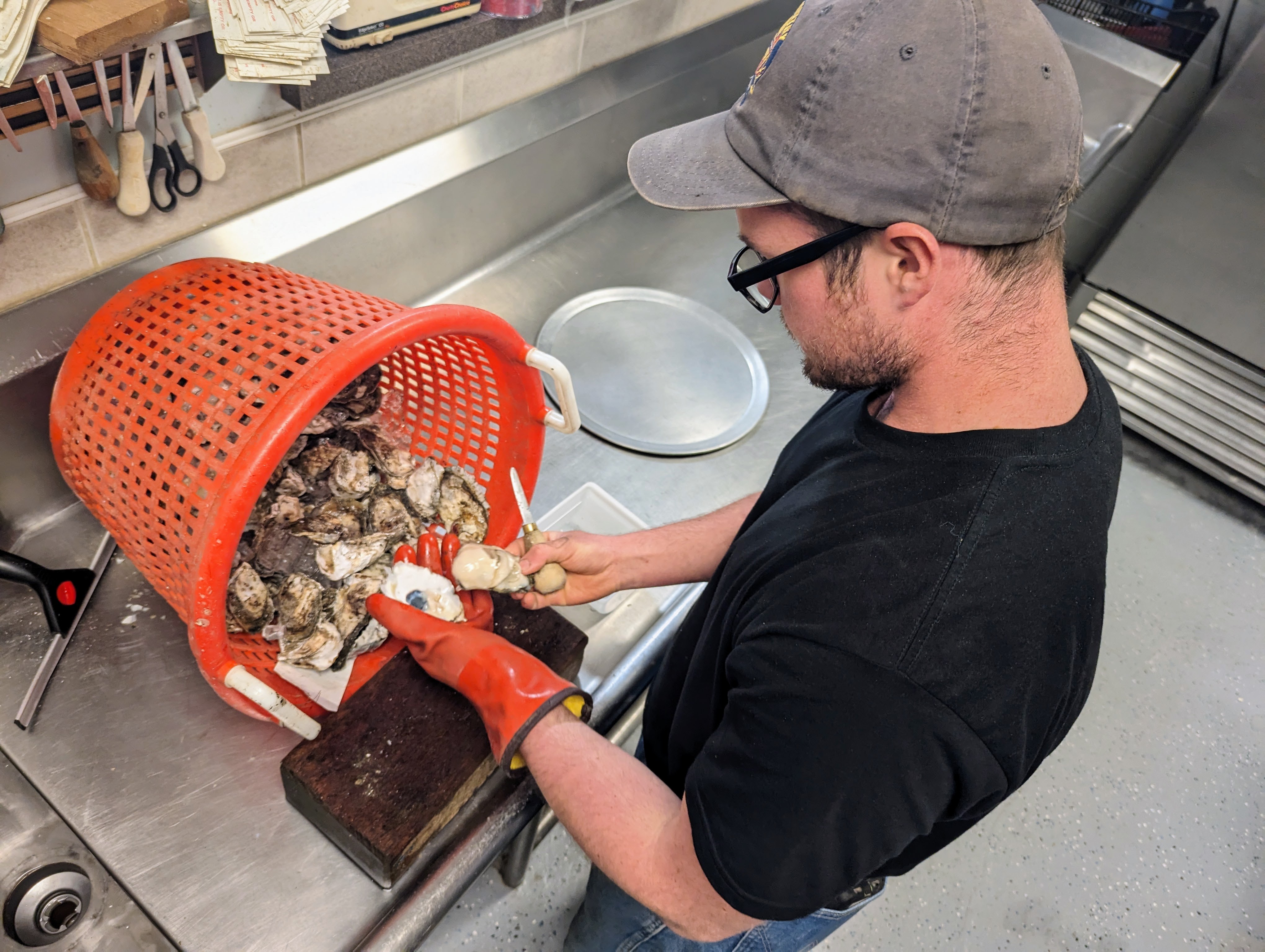 David White shucks oysters at Wild Country Seafood in Annapolis. The small shop specializes in Fatty Pattys, oysters grown on 40 acres in the Rhode River.