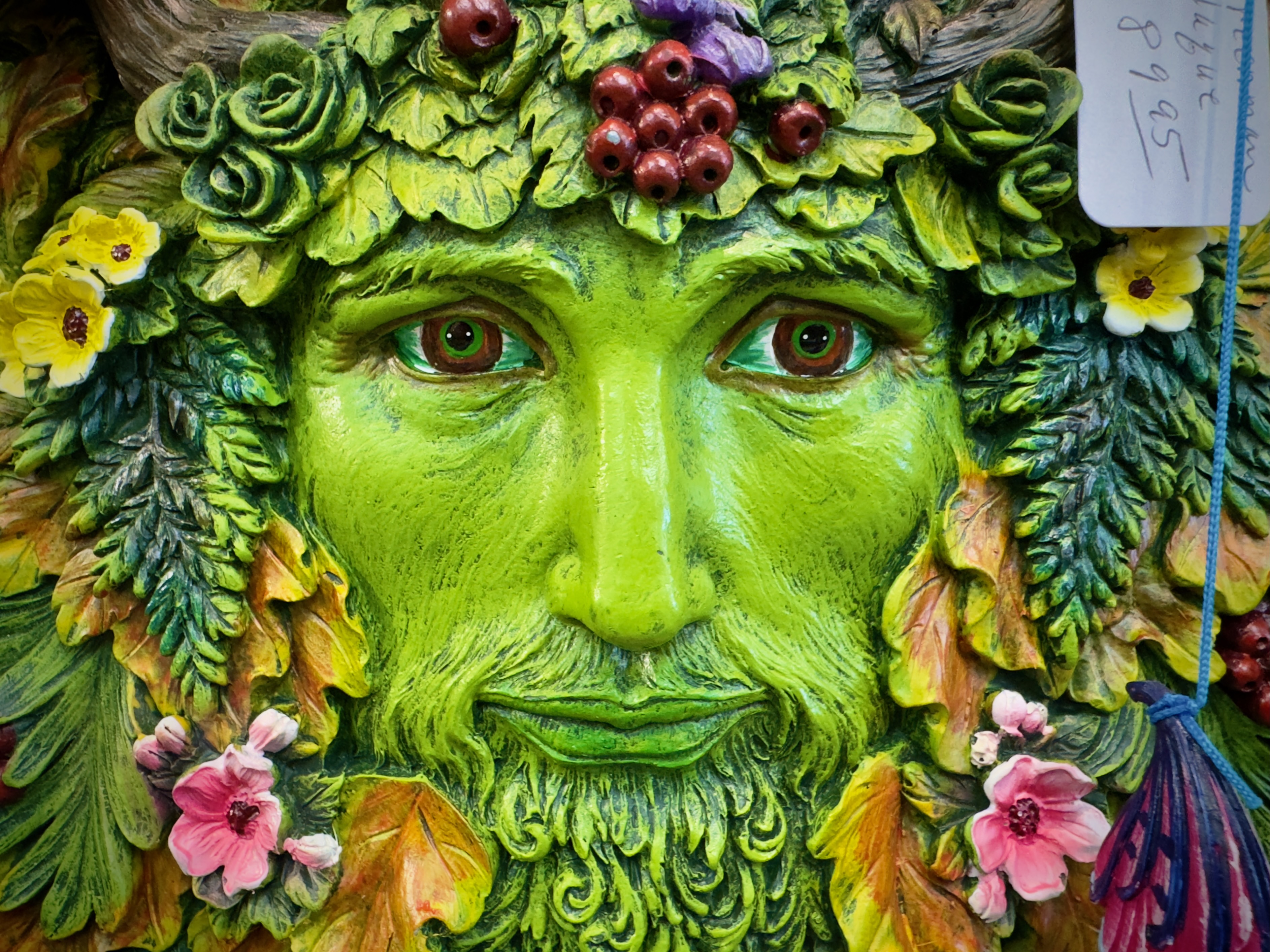 A decorative green man sculpture at The Turning Wheel Bookstore.