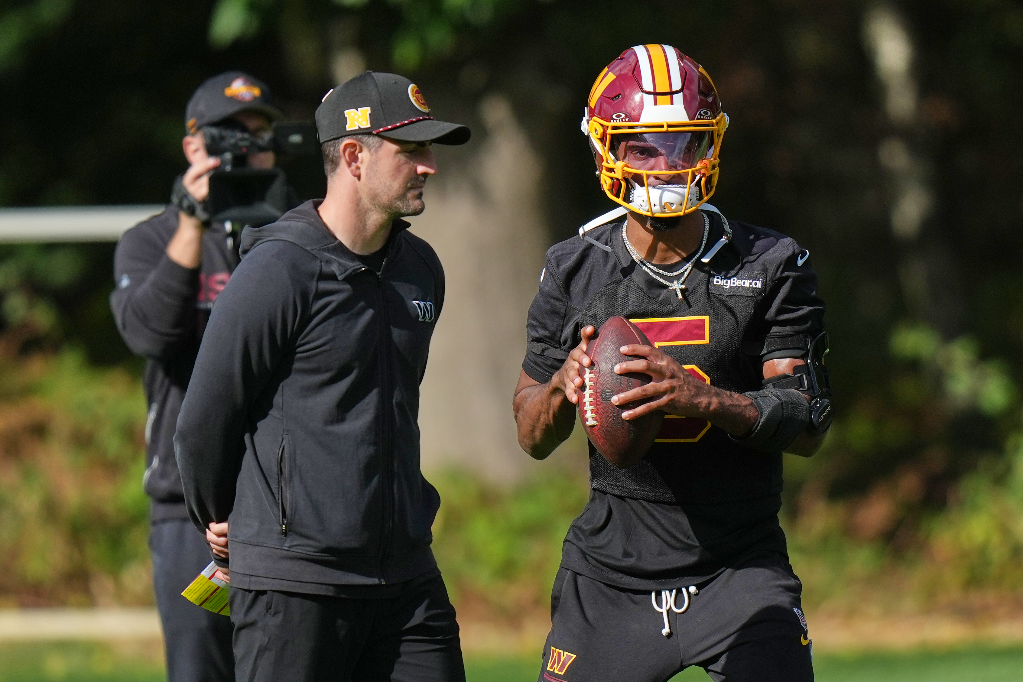 Washington Commanders' quarterback Jayden Daniels holds the ball during practice Friday.