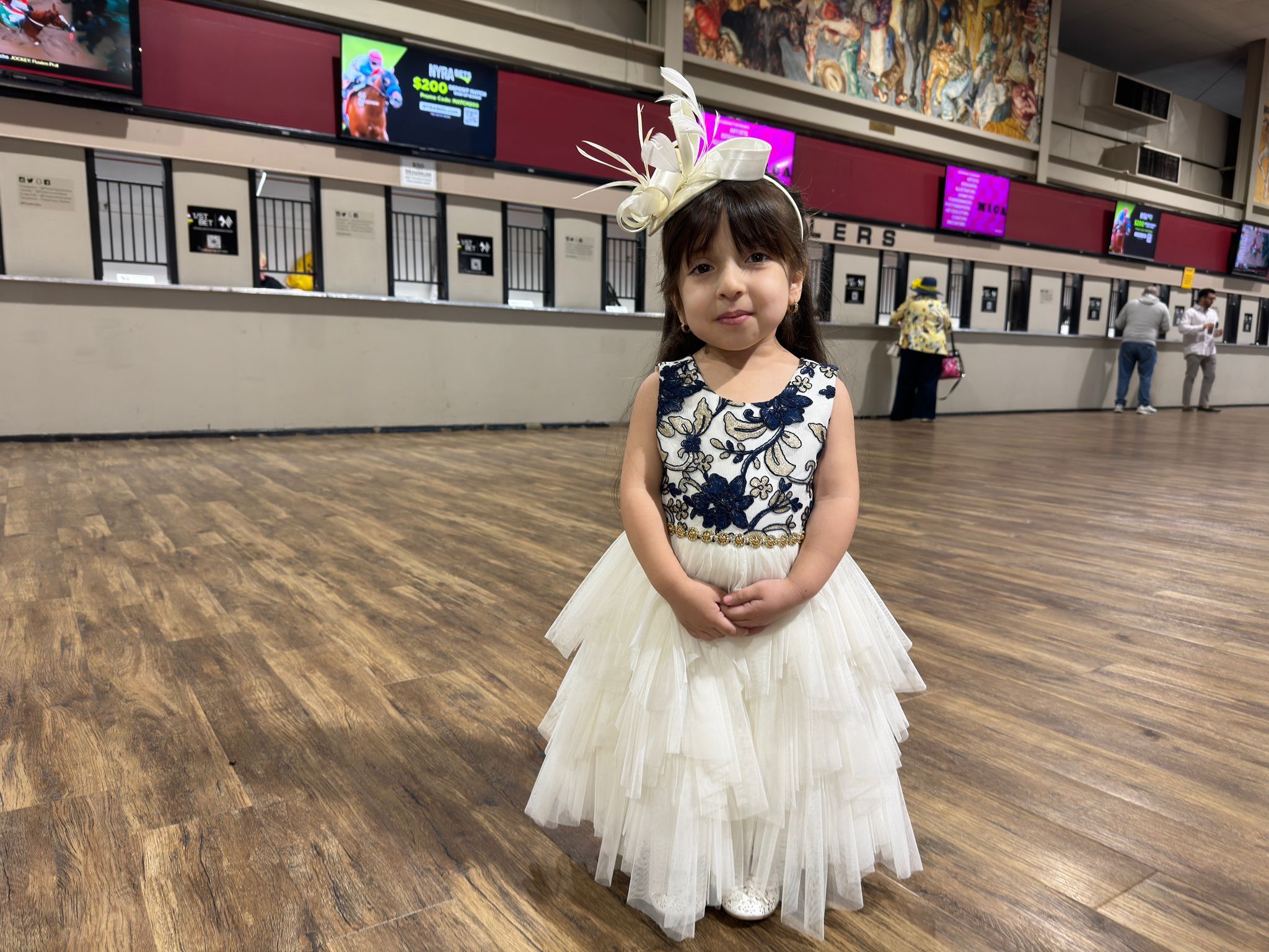 Sara Hernandez, 5, shines at the Preakness Stakes, despite the cloudy and wet weather outside. (Clara Longo de Freitas/The Baltimore Banner)