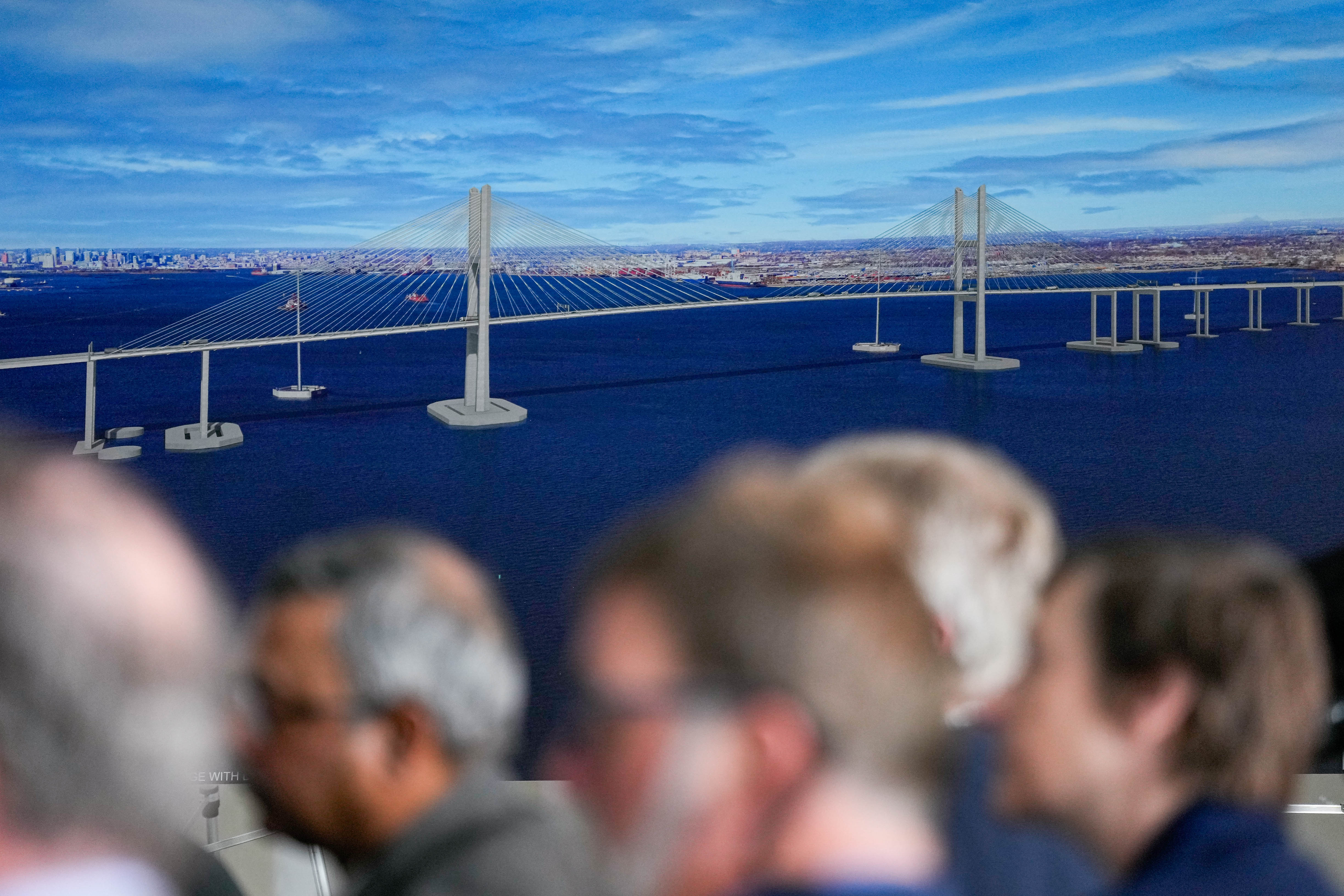 News conference attendees listen to remarks being given about the newly unveiled design for the Francis Scott Key bridge rebuild at Tradepoint Atlantic in Edgemere, Md. on Tuesday, February 4, 2025.